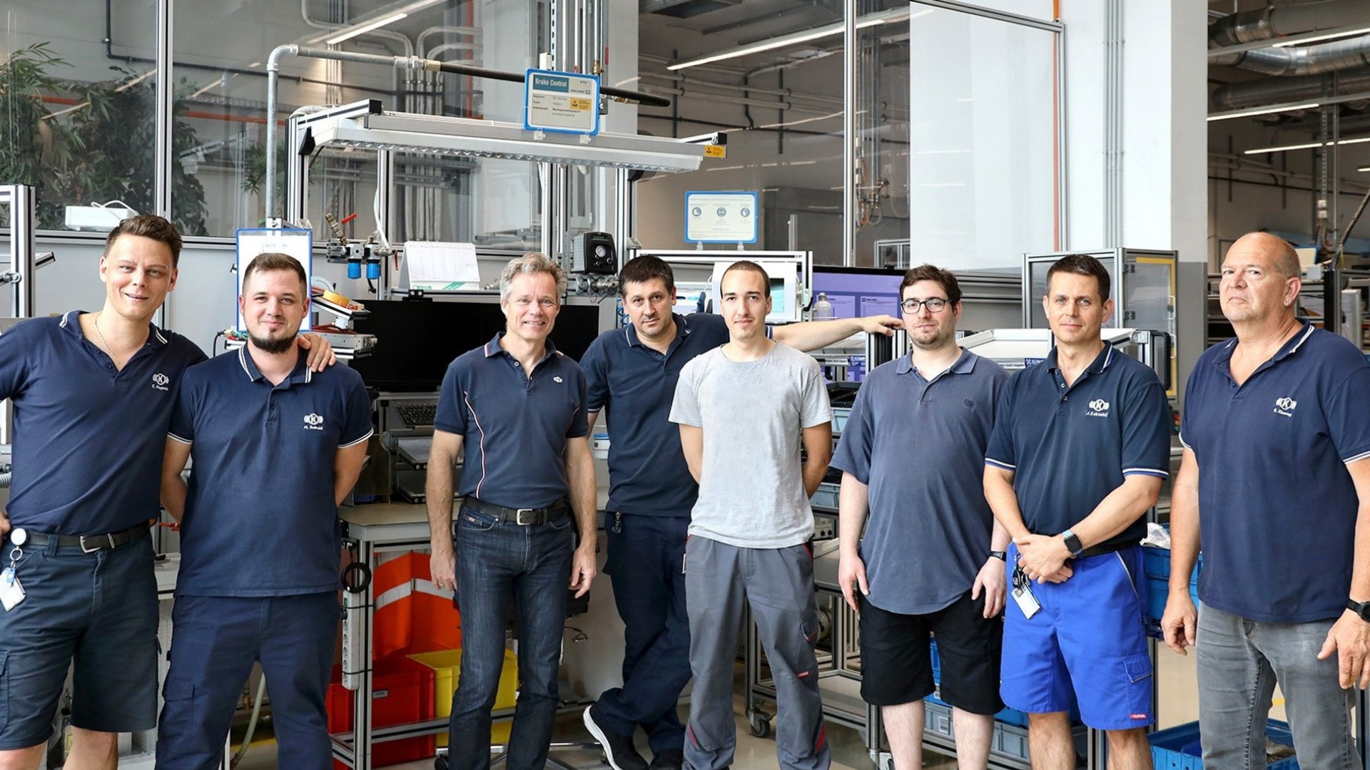 Knorr-Bremse employees posing in manufacturing facility