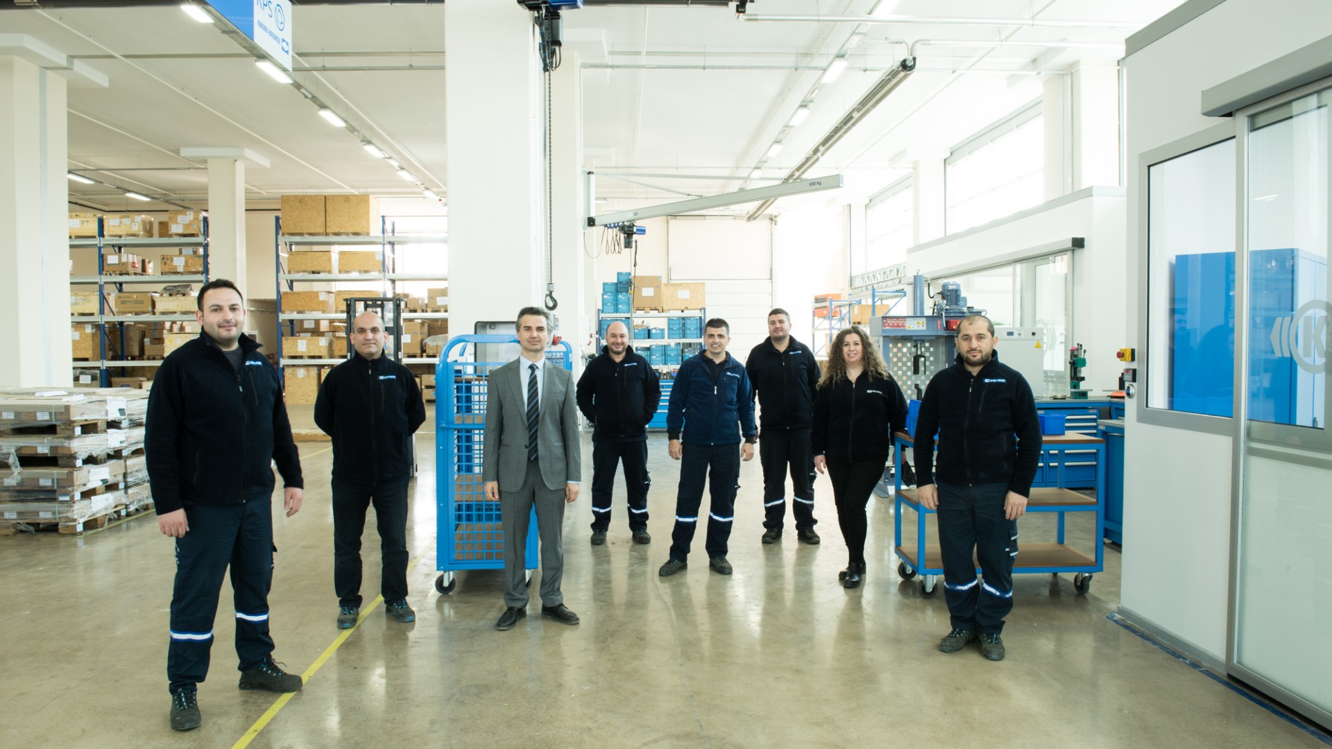 Group of professionals in industrial workspace setting.