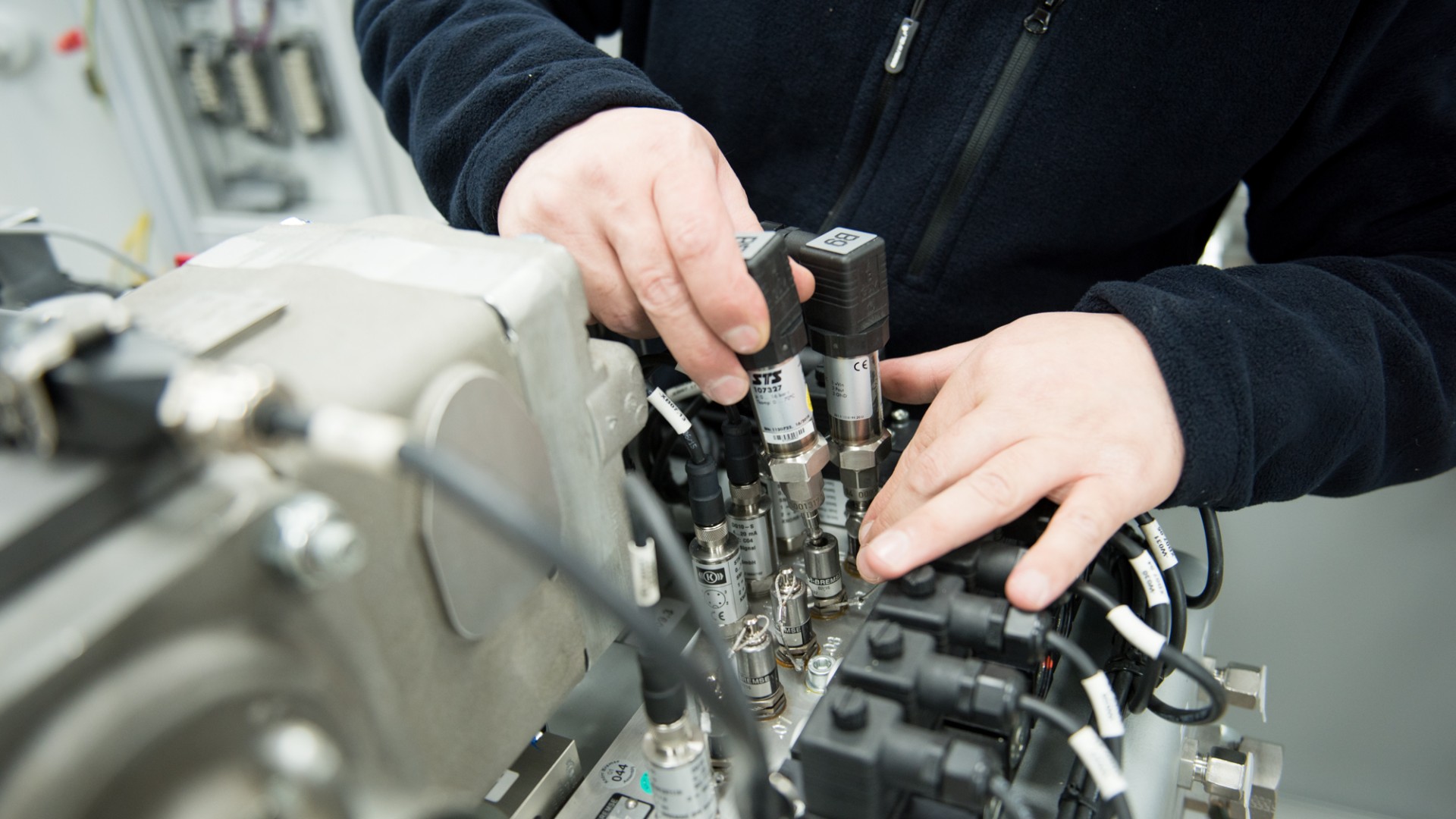Technician assembling components on machinery equipment.