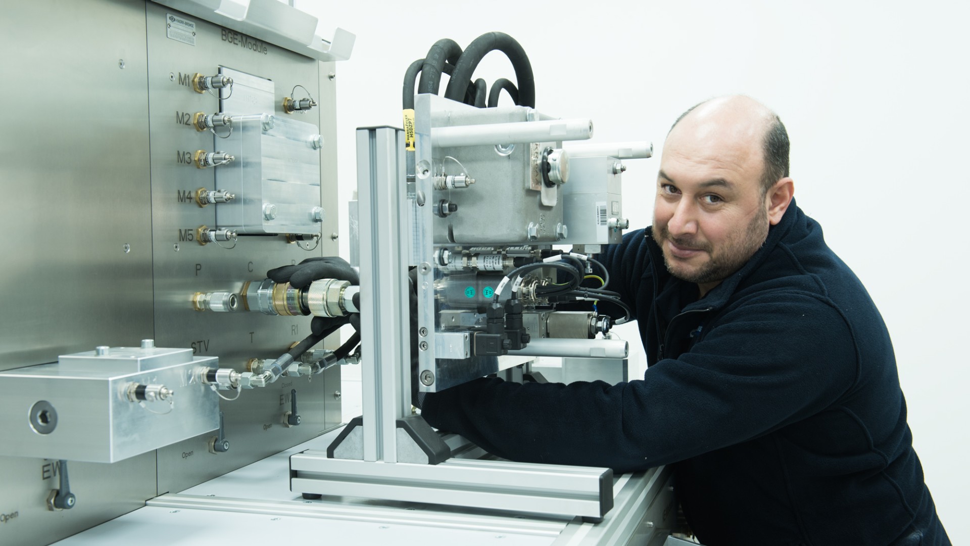 Technician working on industrial machinery assembly.