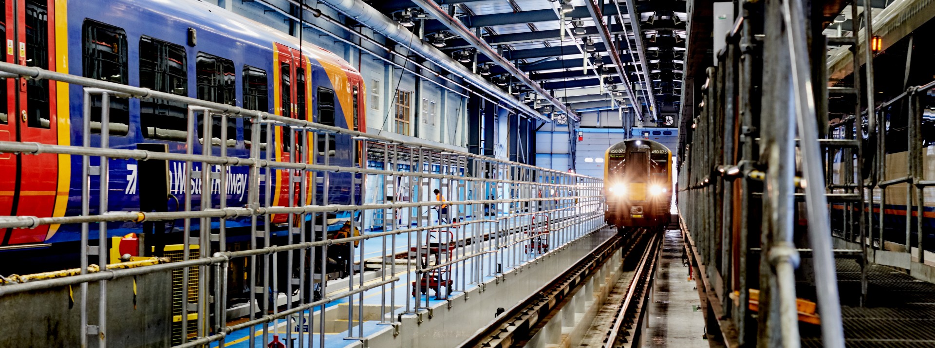 Modern train maintenance facility with multiple trains.