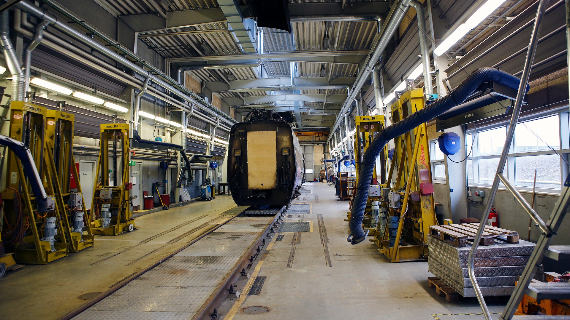Railway maintenance facility with vehicle inspection equipment.