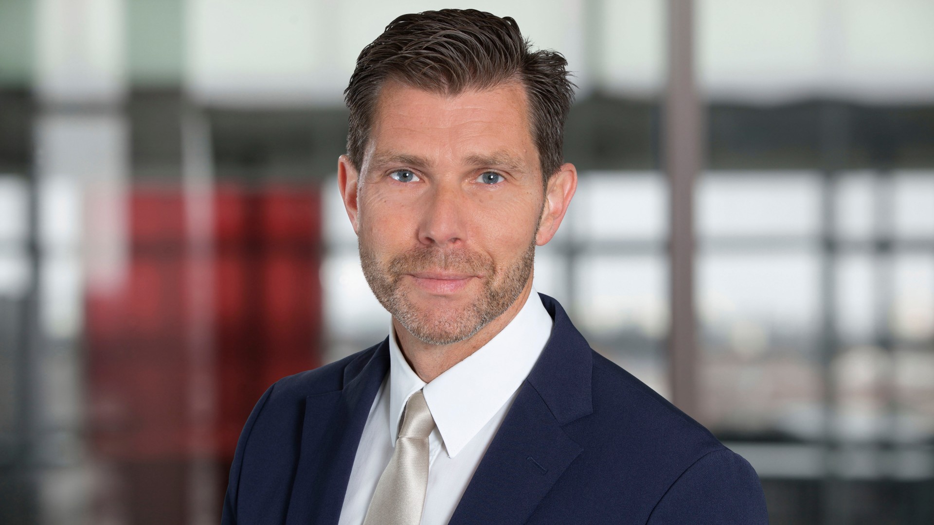 Professional man in suit against blurred background.