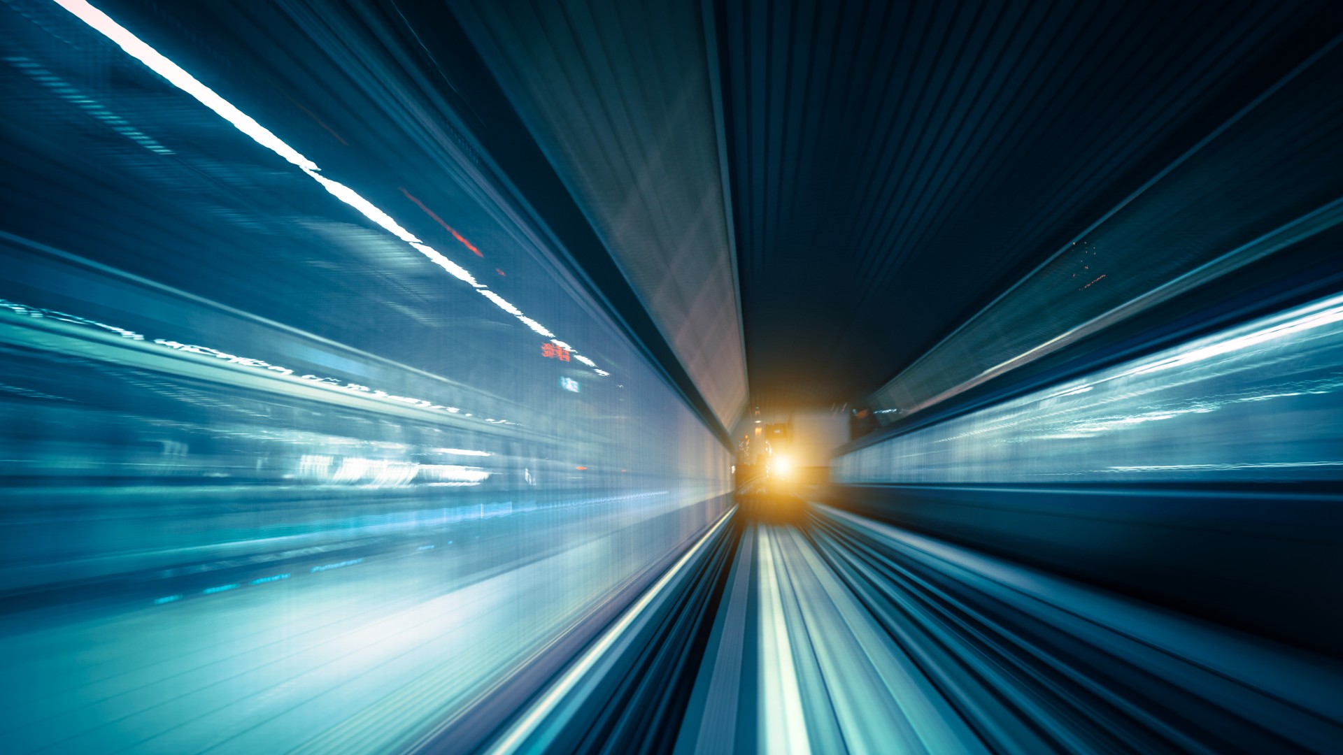 Blurred motion of train in underground tunnel.