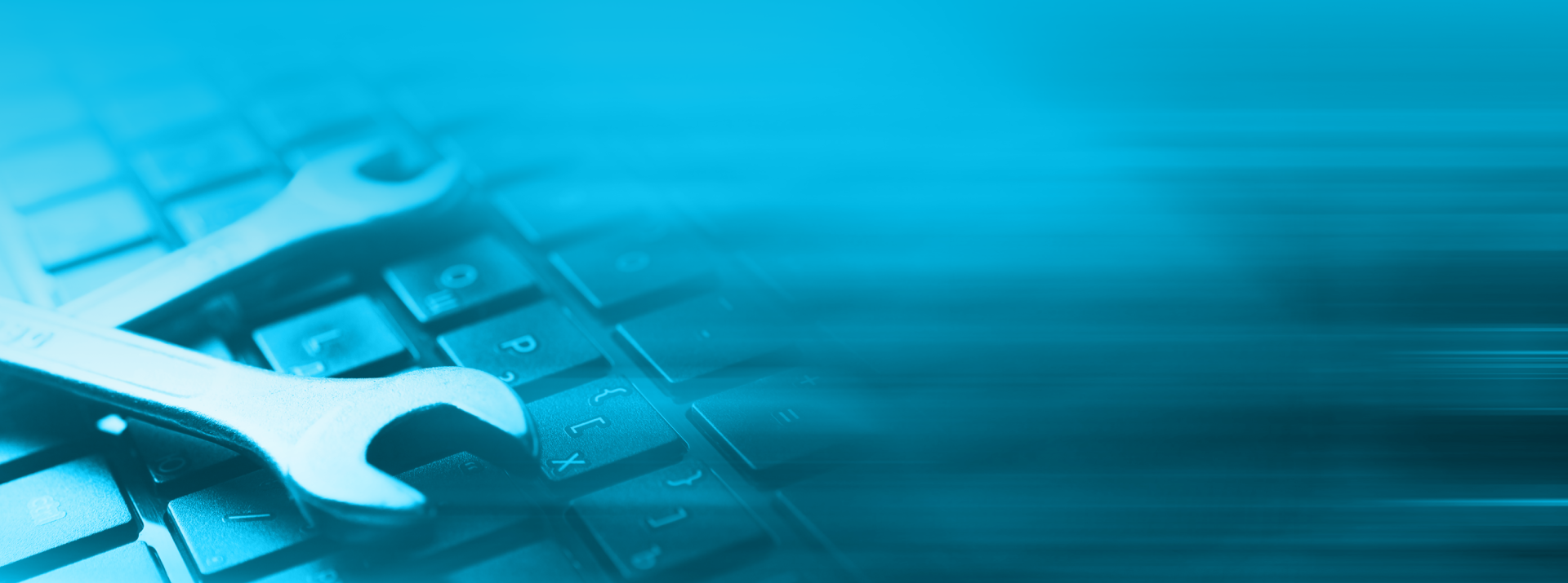 Wrenches on a keyboard with blue background