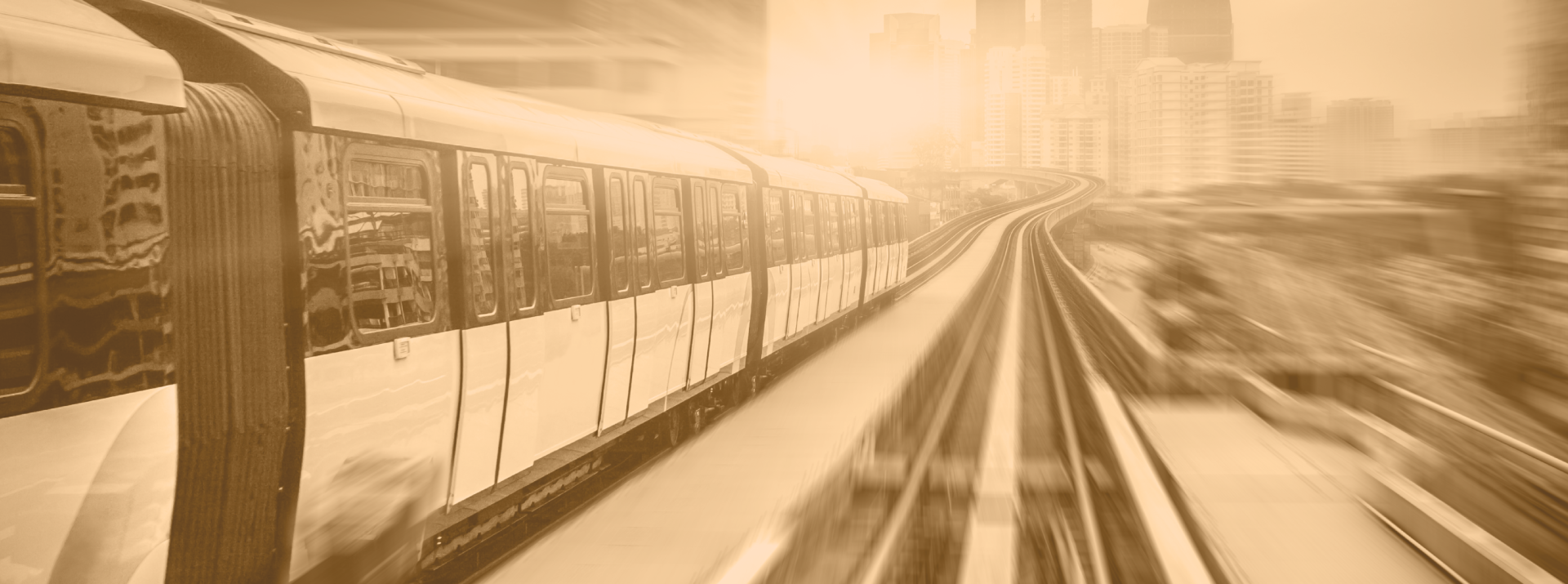 Blurred train moving through a cityscape background.