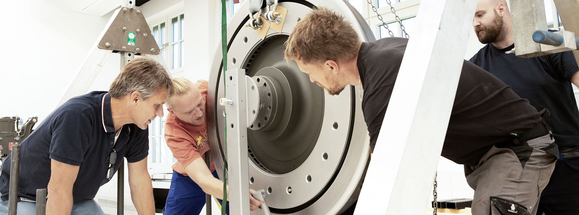 Technicians inspecting a large mechanical component together.