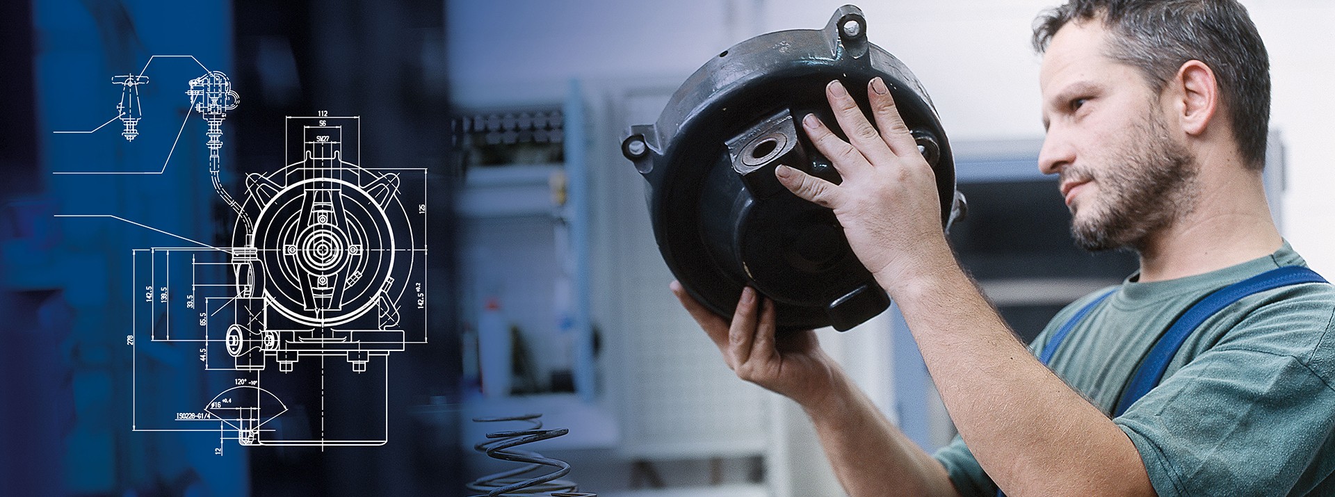 Employee inspecting mechanical component with technical drawings.