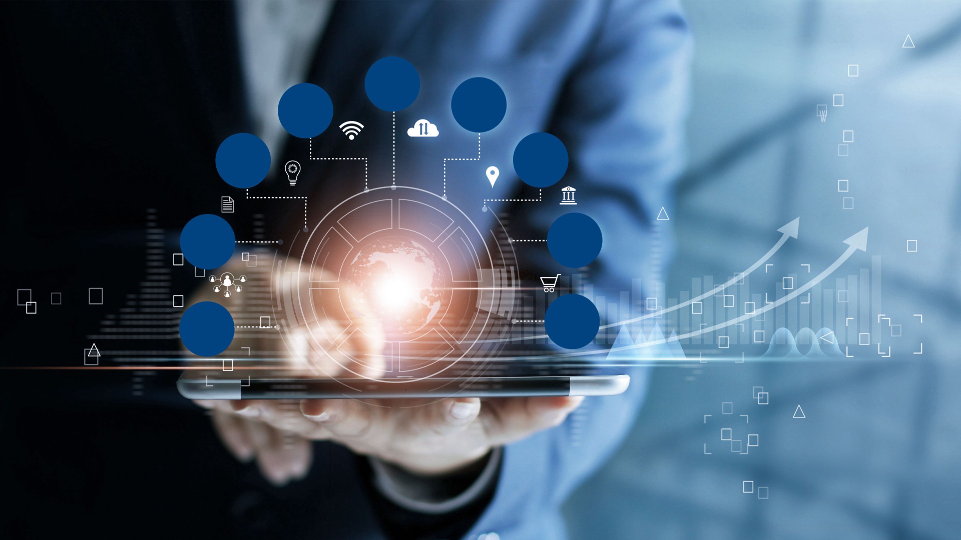 Businessman using tablet with digital data visuals.