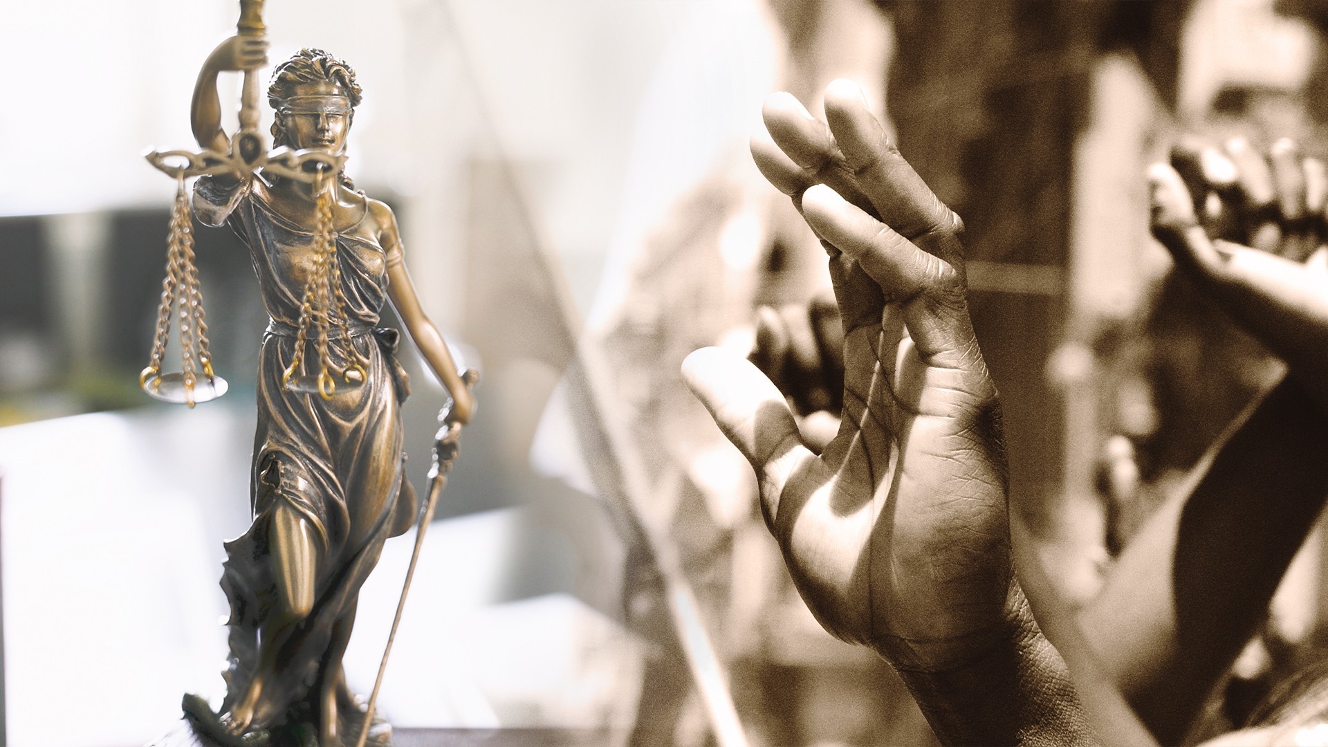 Lady Justice statue alongside raised hands in
