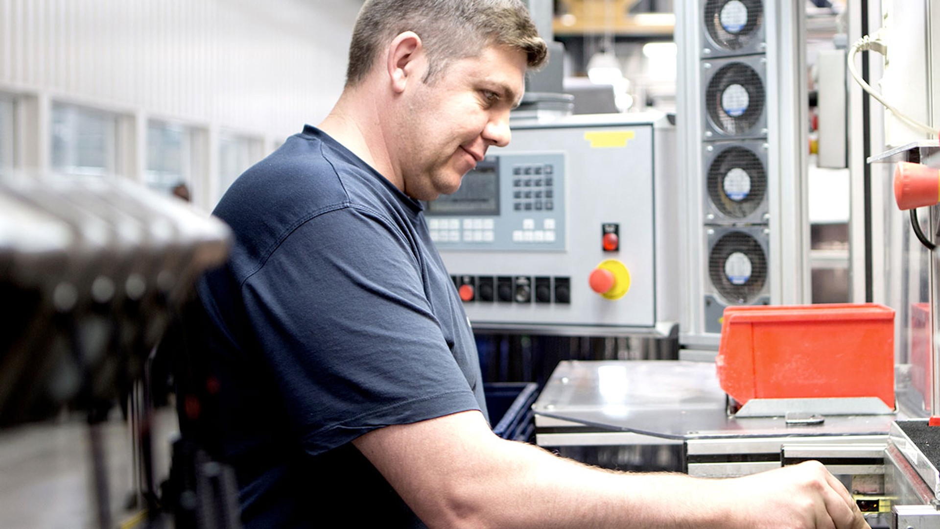 Worker operating machinery in a manufacturing facility.