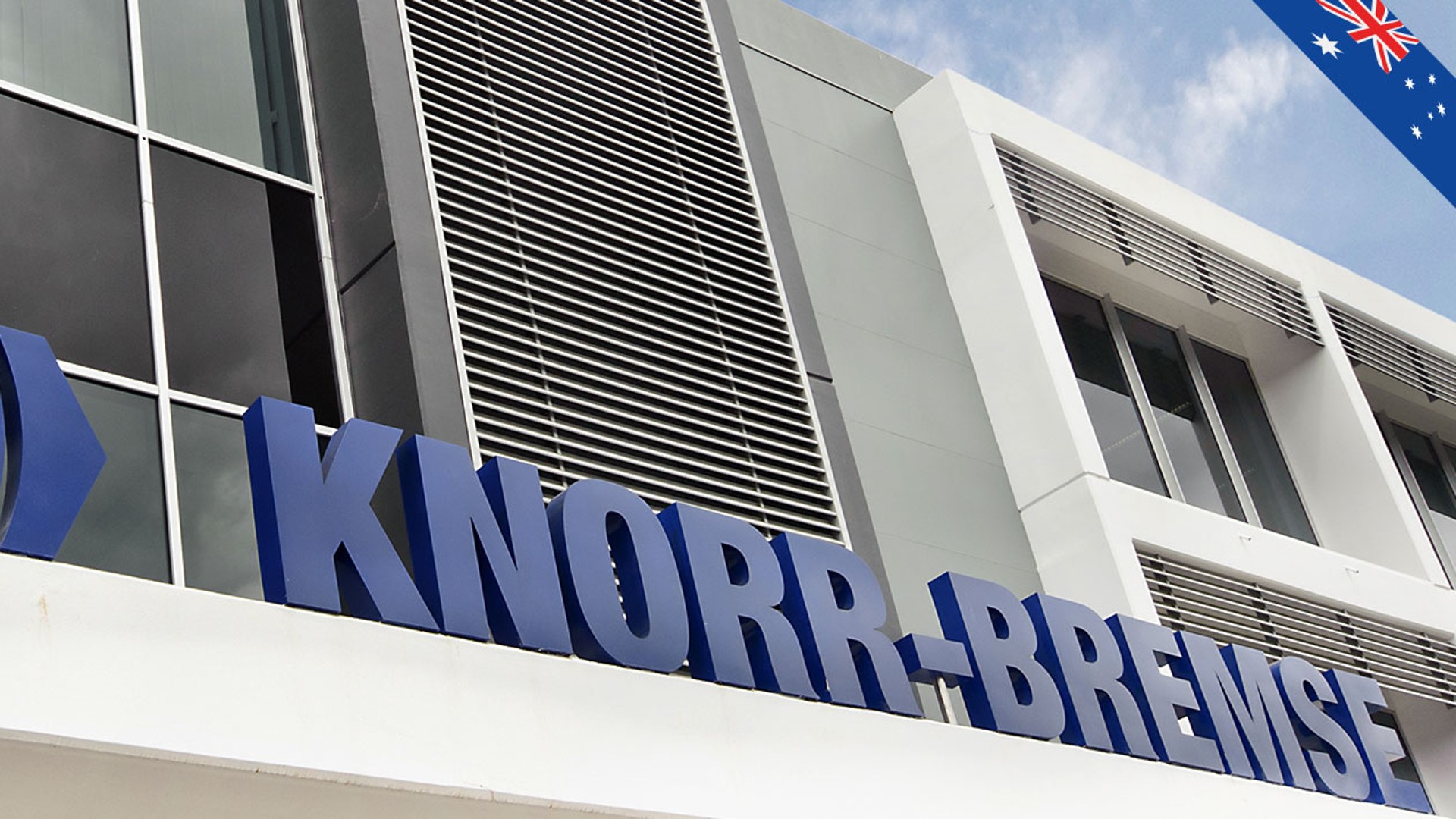 Knorr-Bremse company sign outside modern building.
