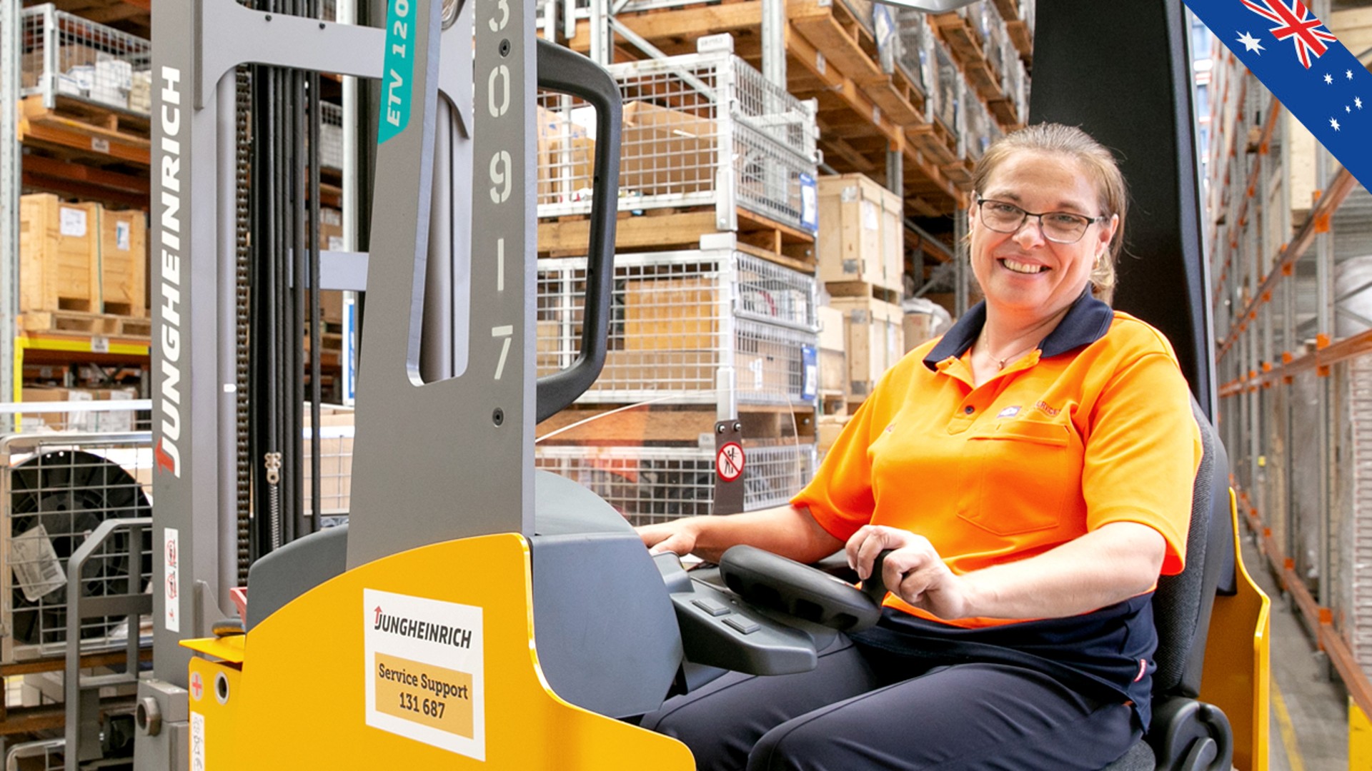 Warehouse worker operating forklift in storage facility.