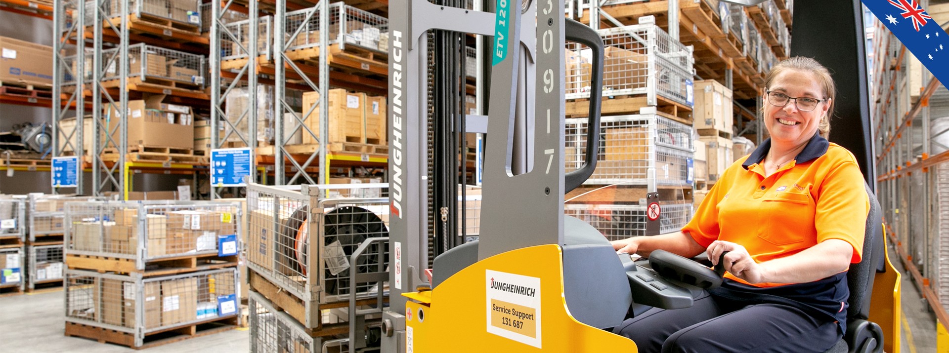 Warehouse worker operating forklift in storage facility.
