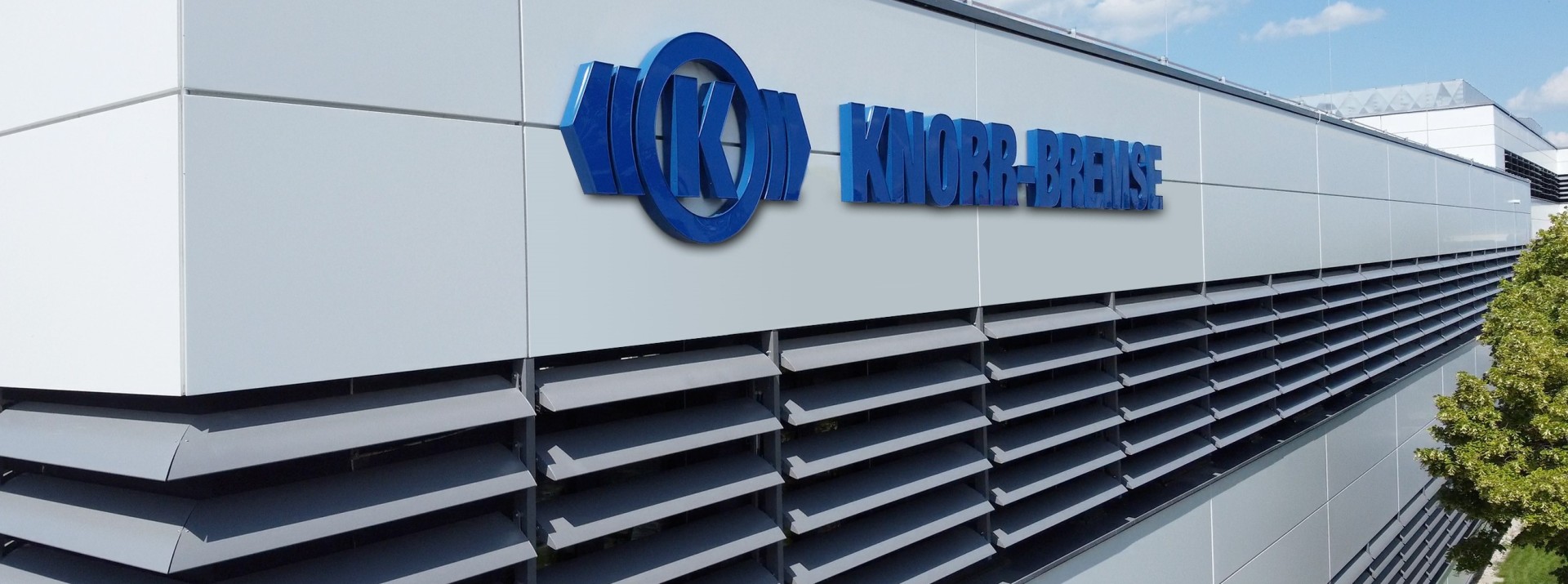 Knorr-Bremse building with company flags displayed.