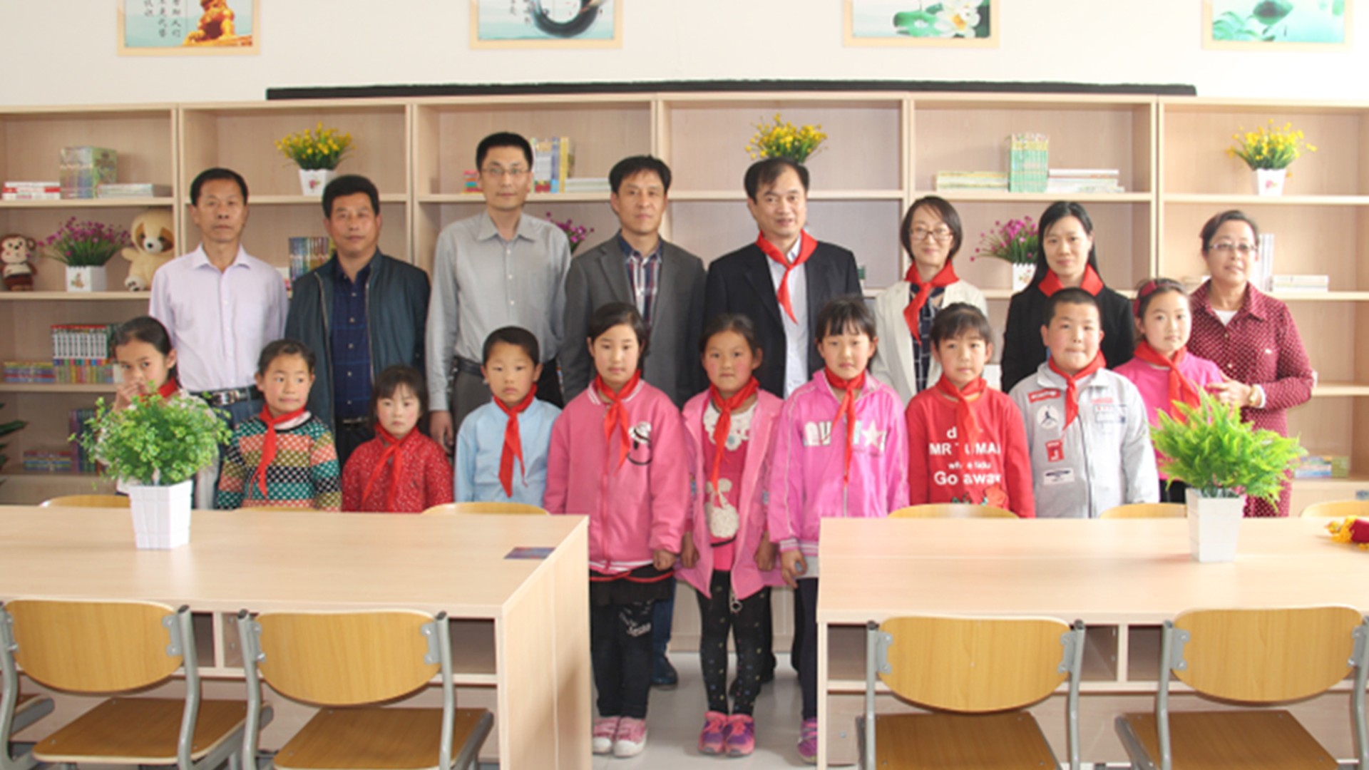 Group of children and adults in classroom