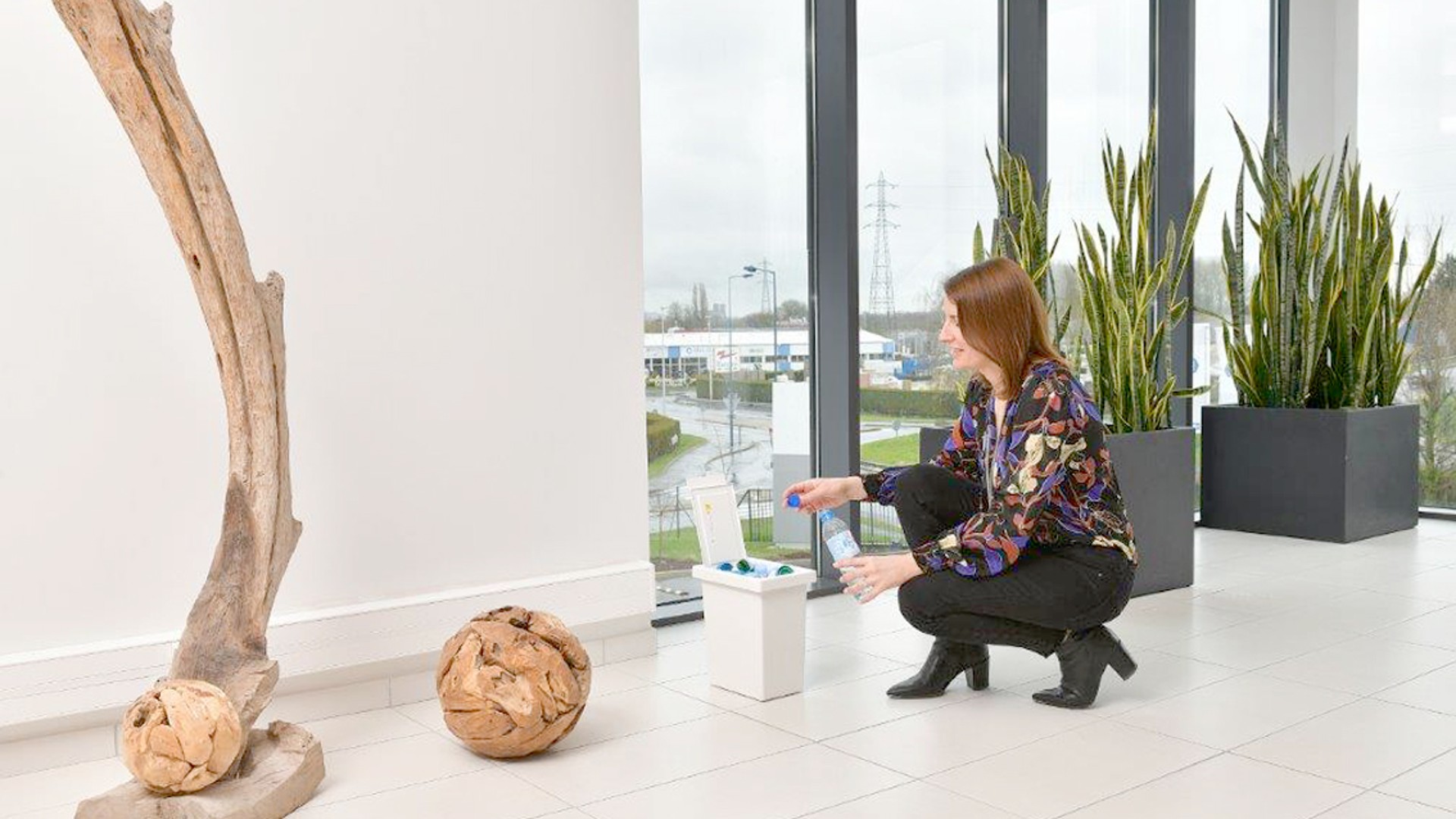 Woman interacting with decorative elements indoors.