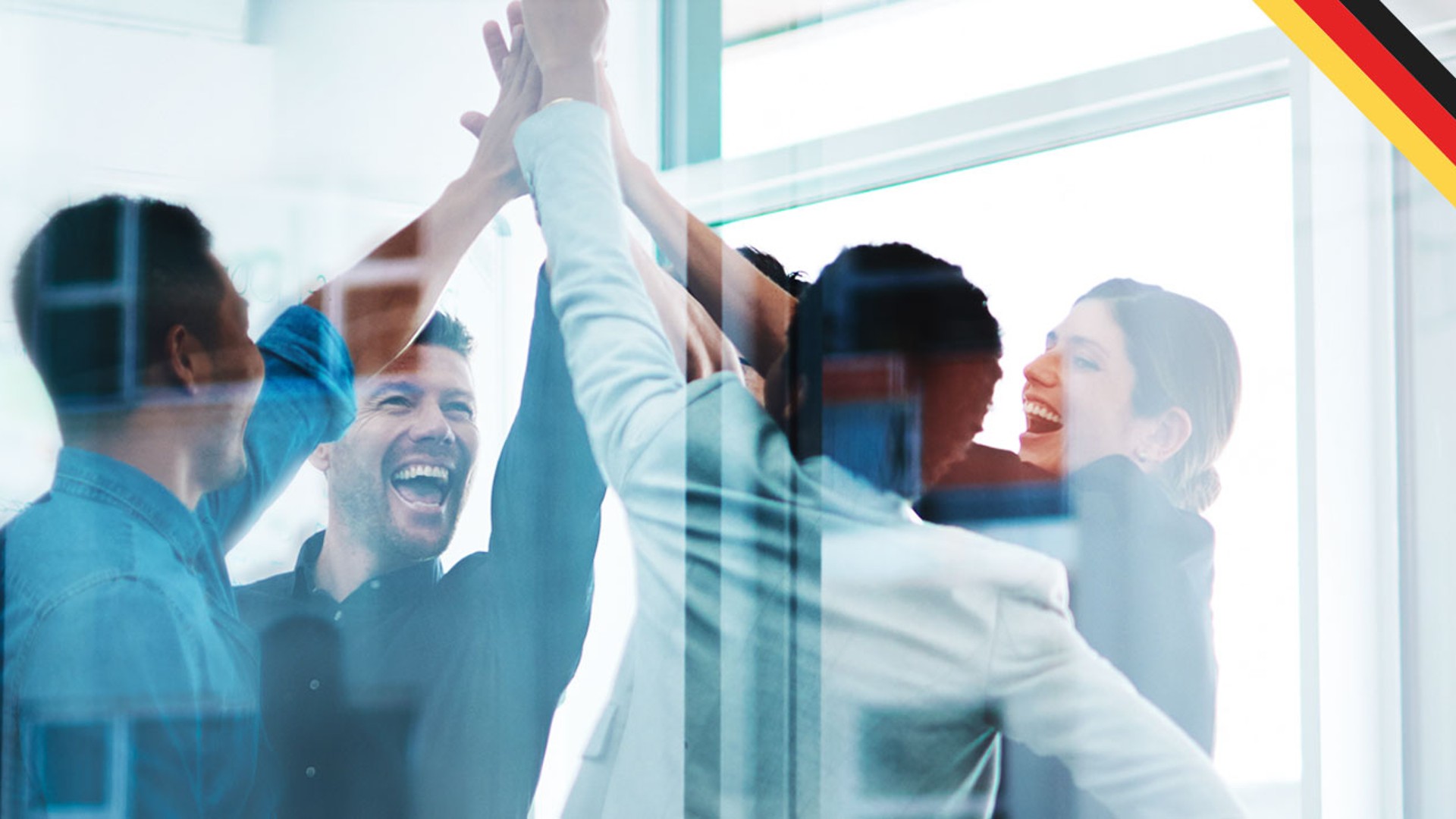 Team celebrating success with high-fives indoors.