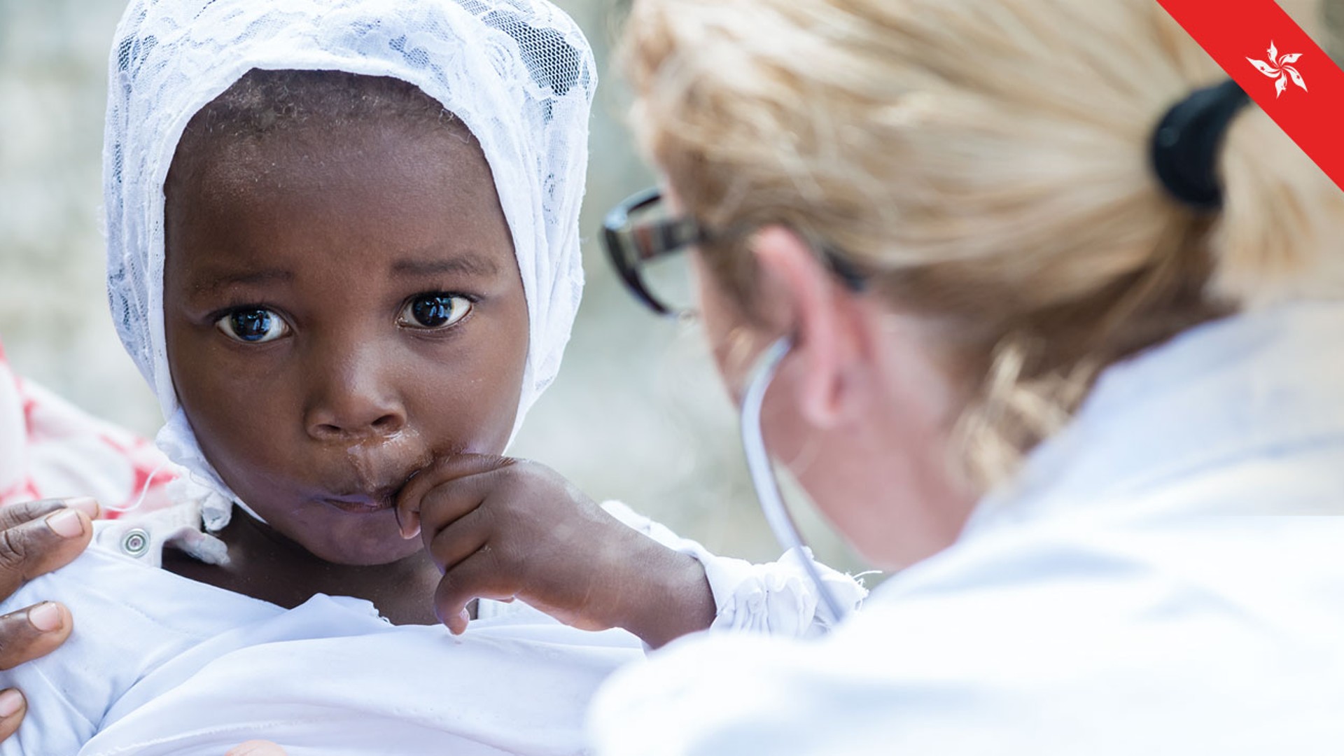 Child receiving care from healthcare professionals with