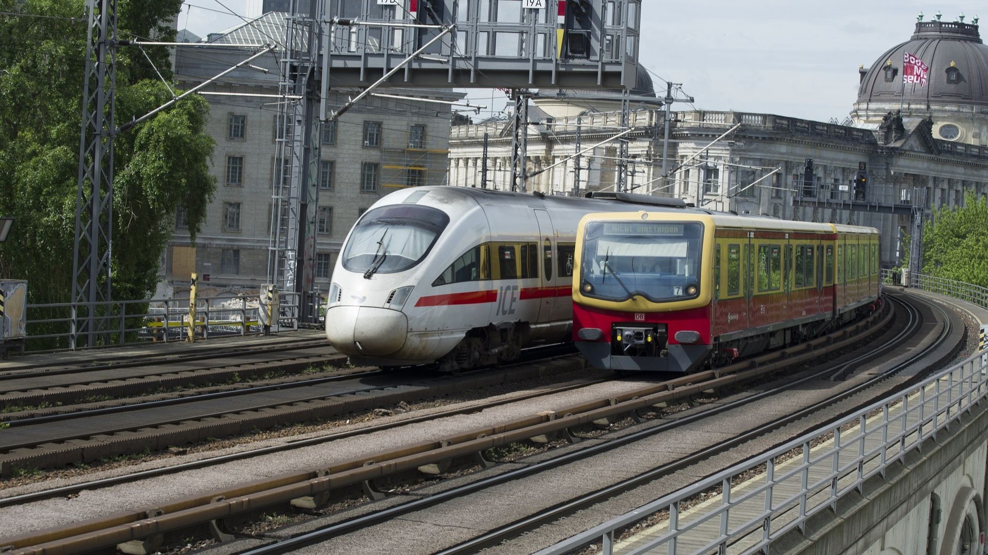 Two trains on railway tracks in urban