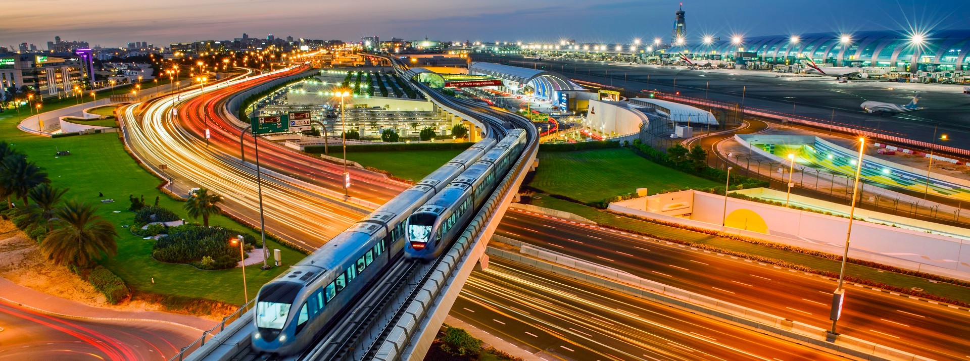 Night view of monorail near airport terminal.