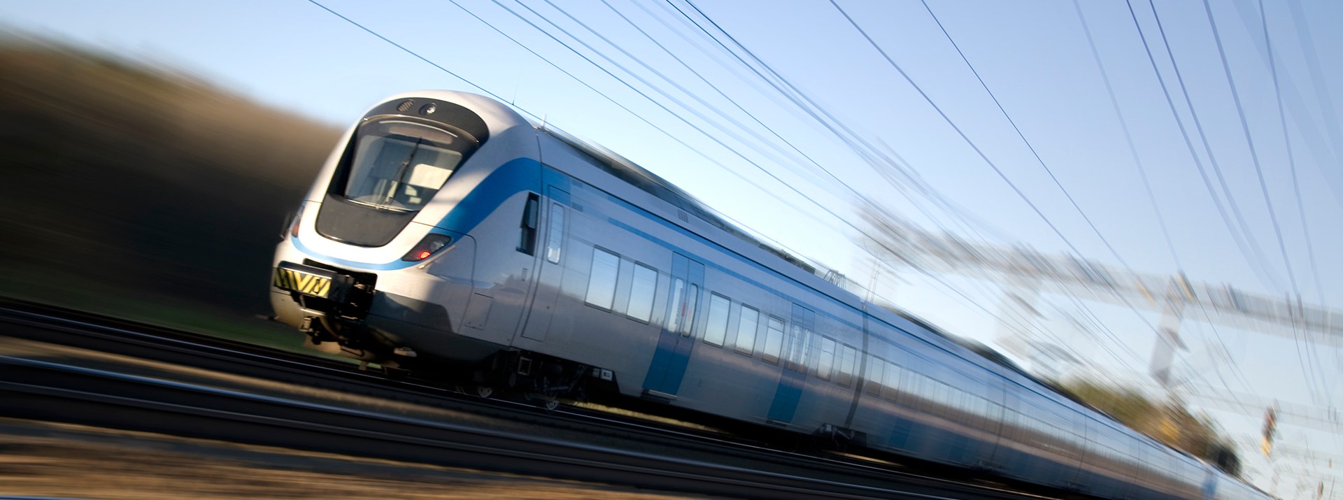 High-speed train in motion on railway tracks.