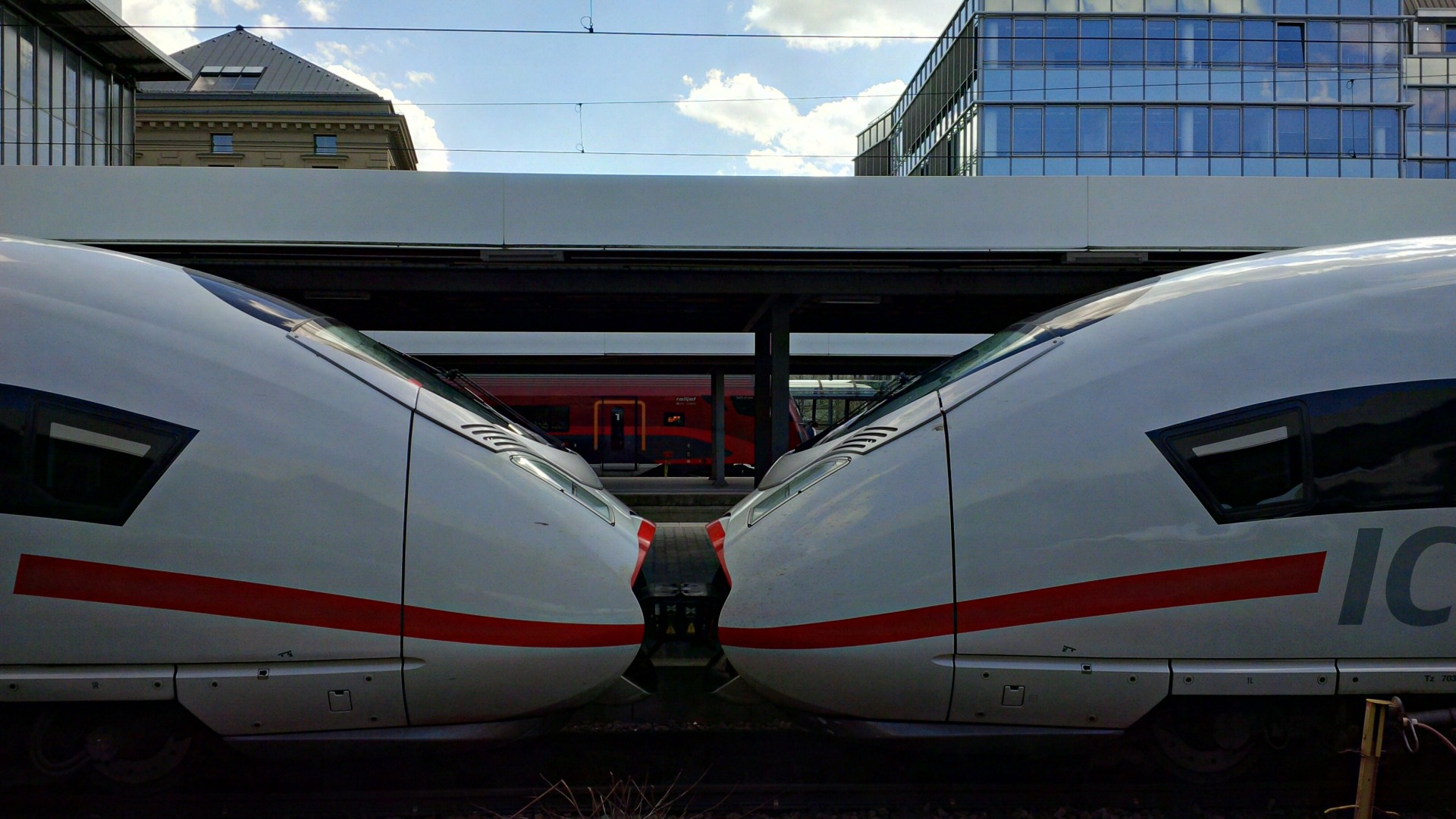 Two high-speed trains positioned at the station.