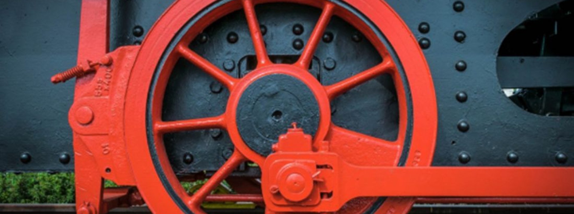 Red train wheel on railroad tracks, industrial