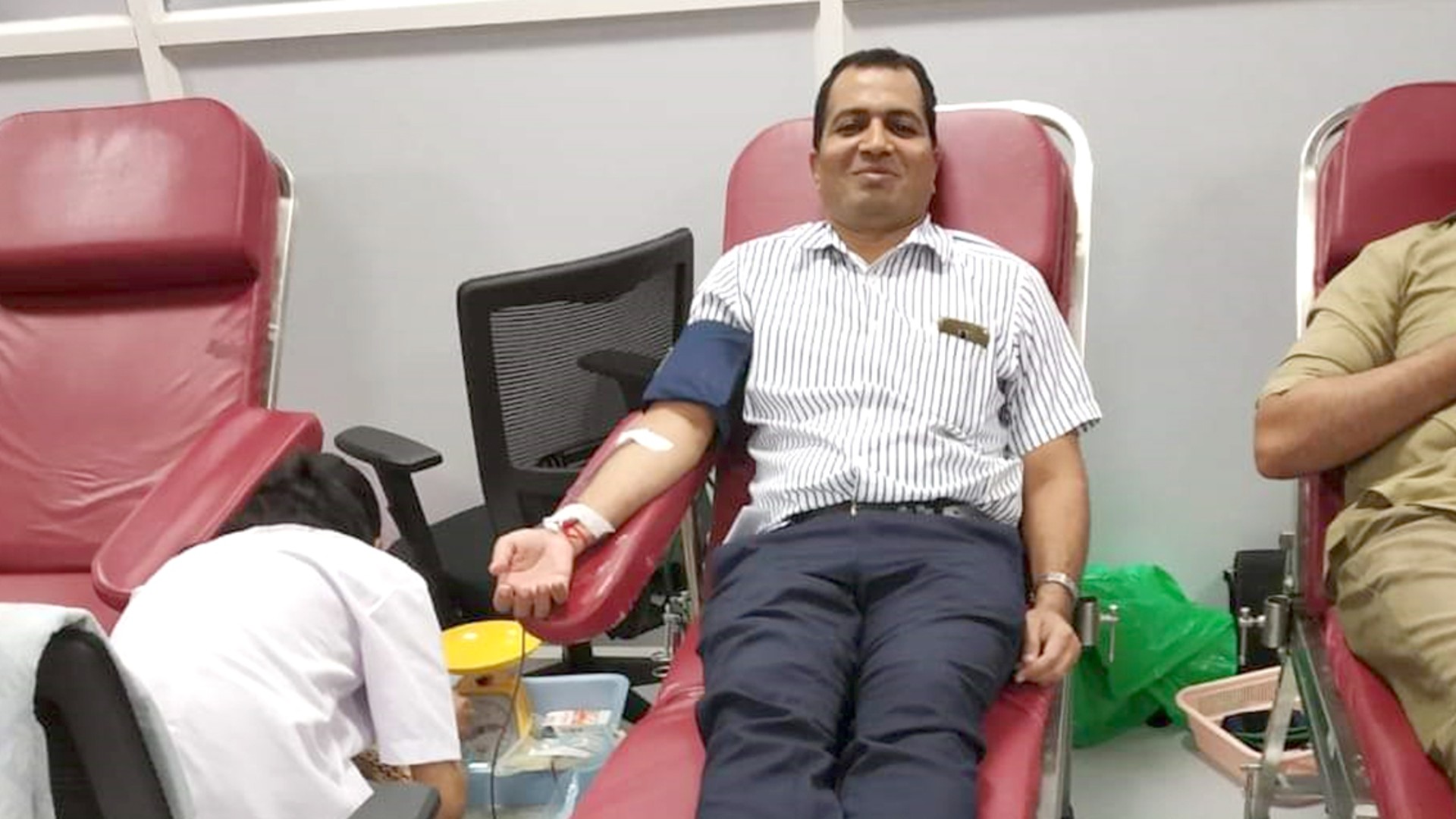 Employee donating blood during a health event.