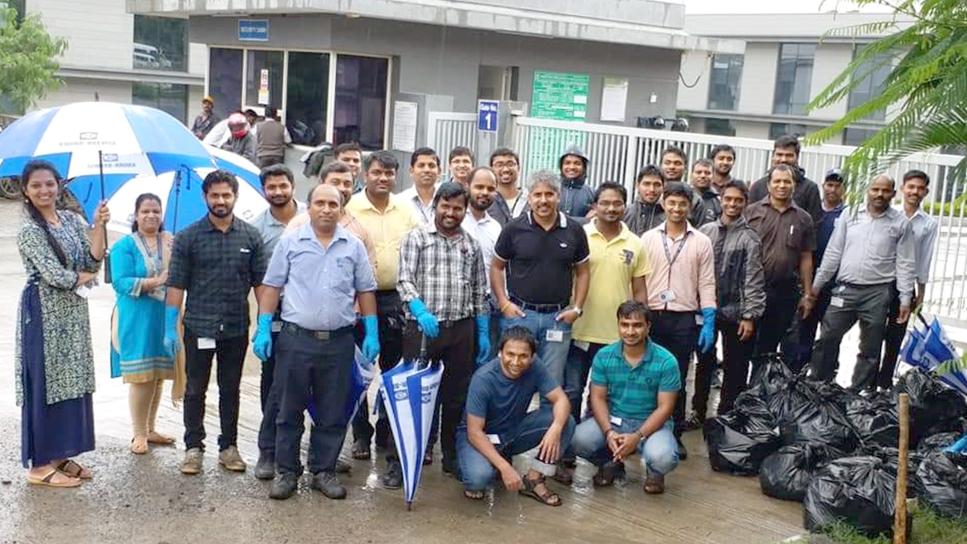 Team volunteer event with collected waste bags.