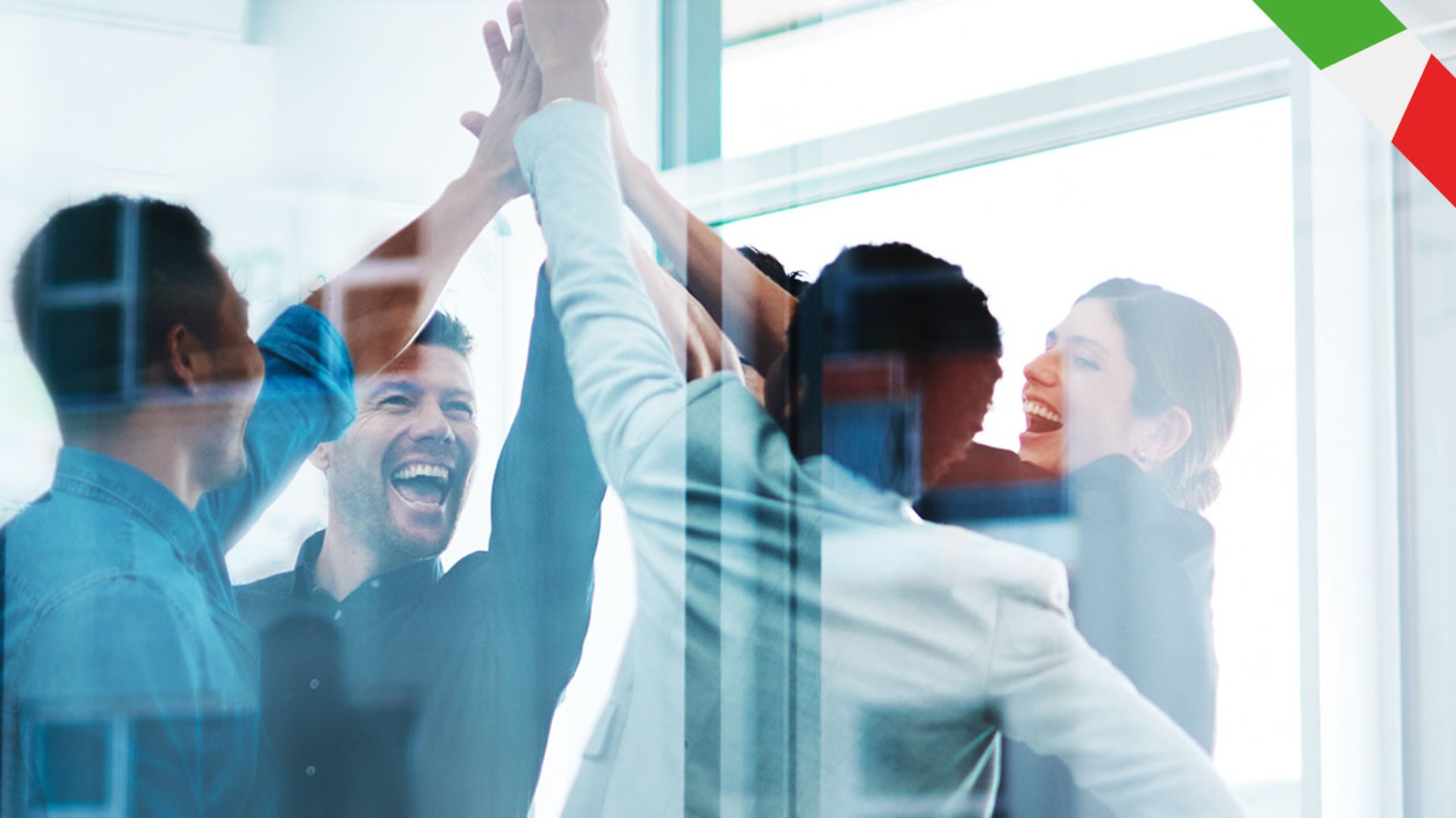 Team celebrating success with high fives indoors.