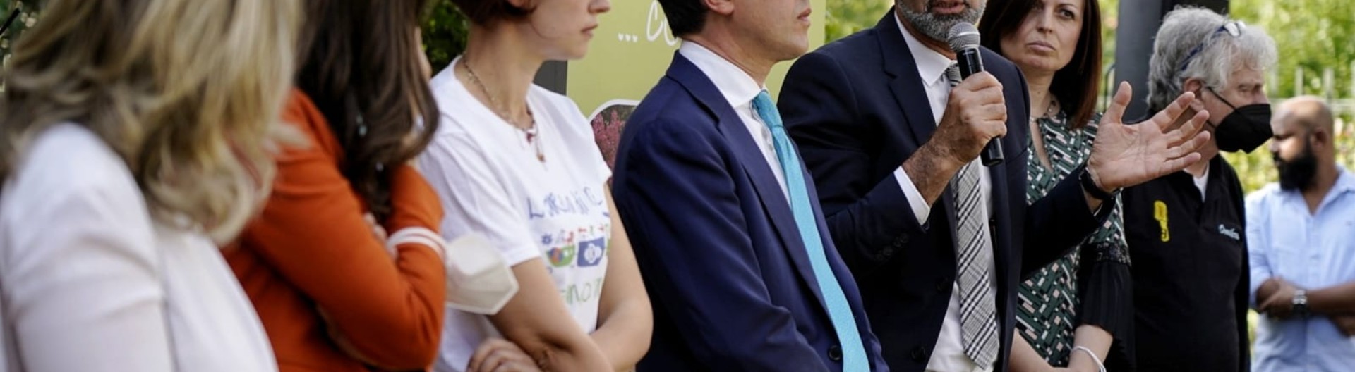 Group of speakers at an outdoor event.