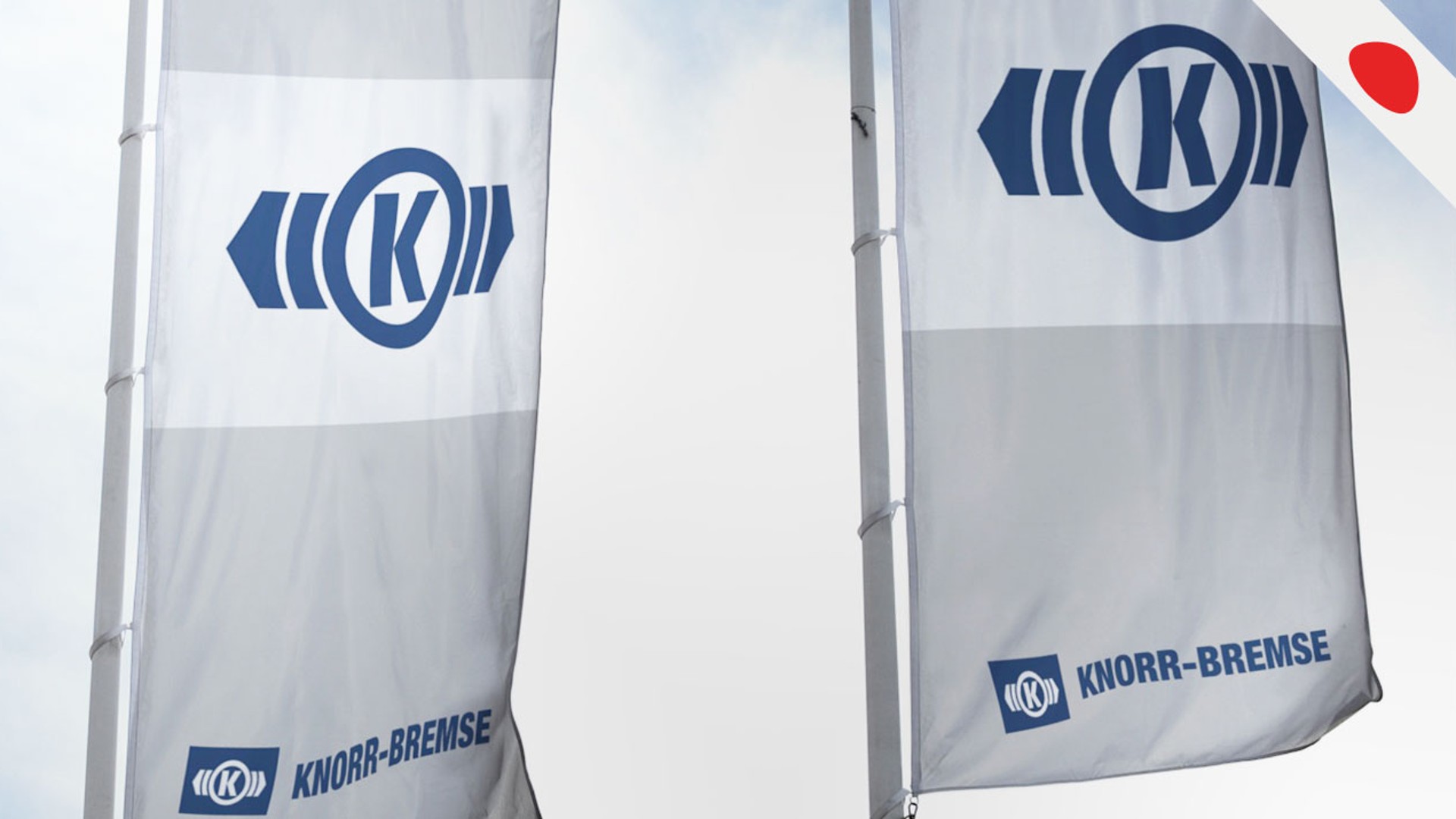 Knorr-Bremse flags displaying company logo outdoors.