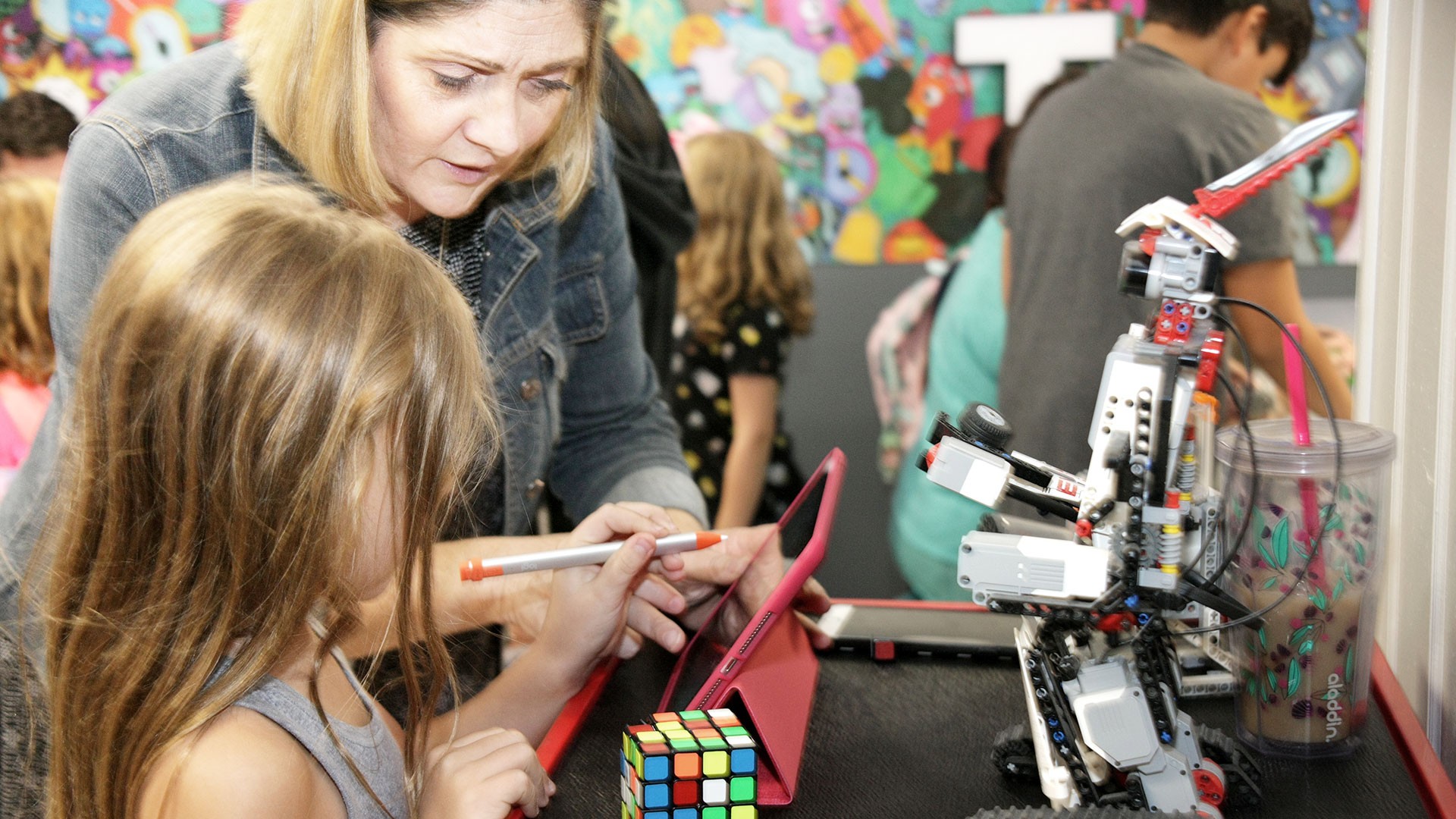 Child and adult interacting with robotics kit