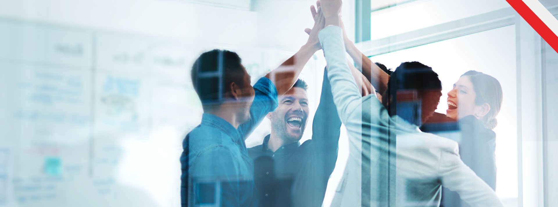 Team celebrating success with high-fives in office.