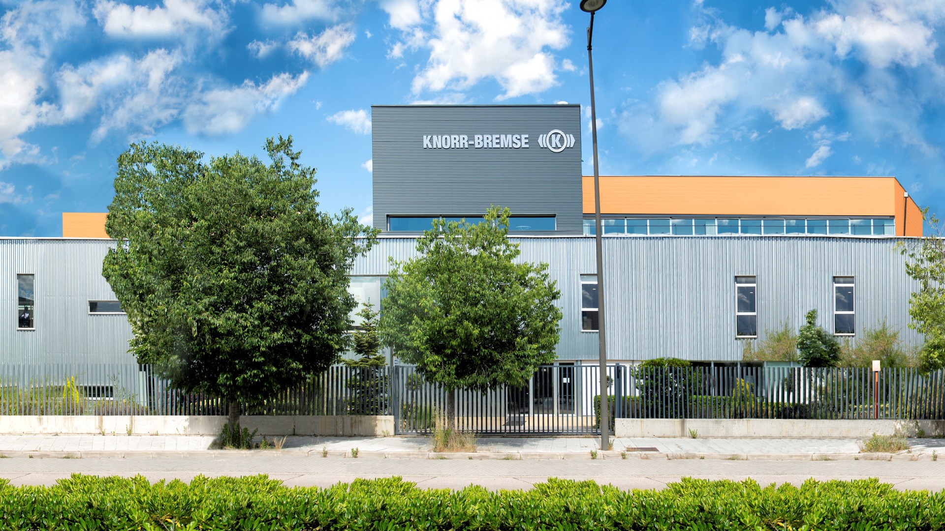 Knorr-Bremse building with lush greenery in foreground