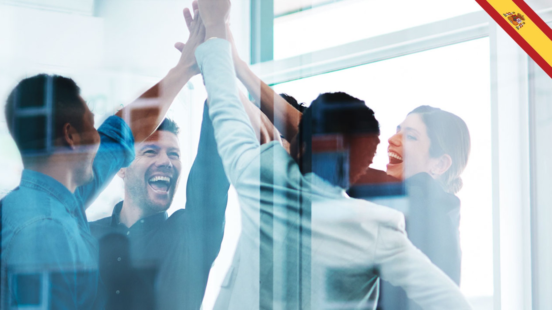Team celebrating success with high-fives in office.
