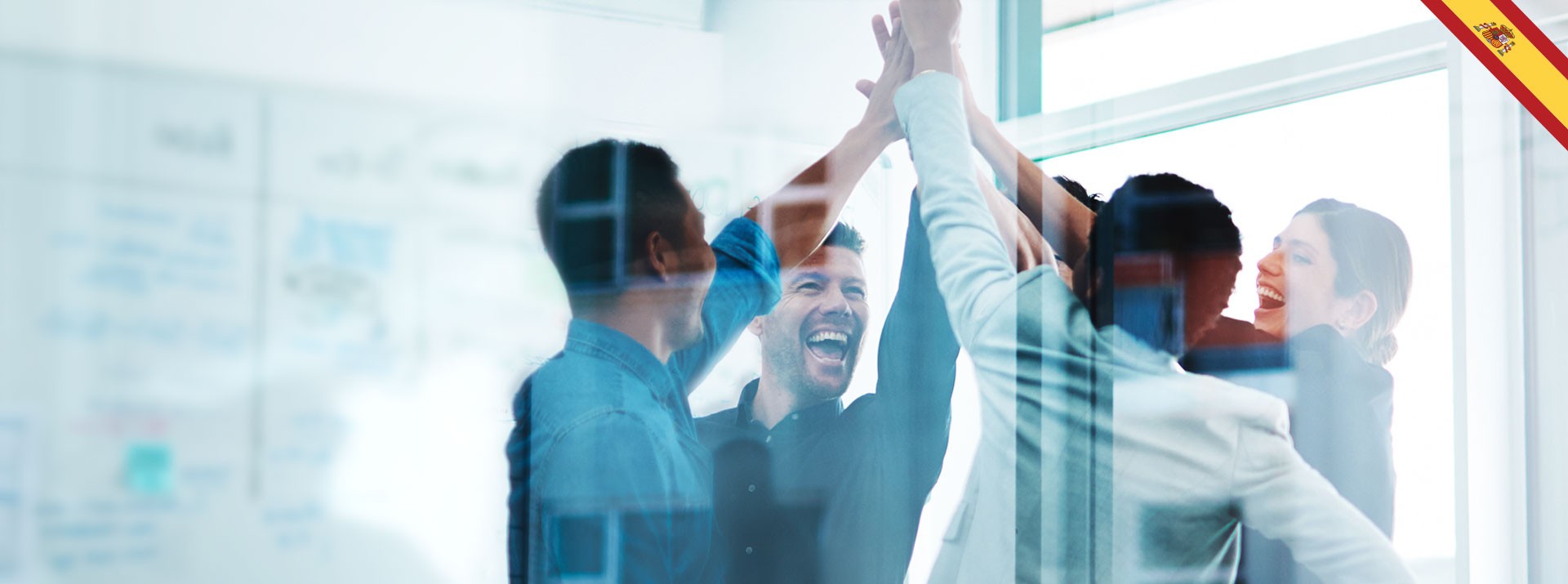 Team celebrating success with high-fives in office.