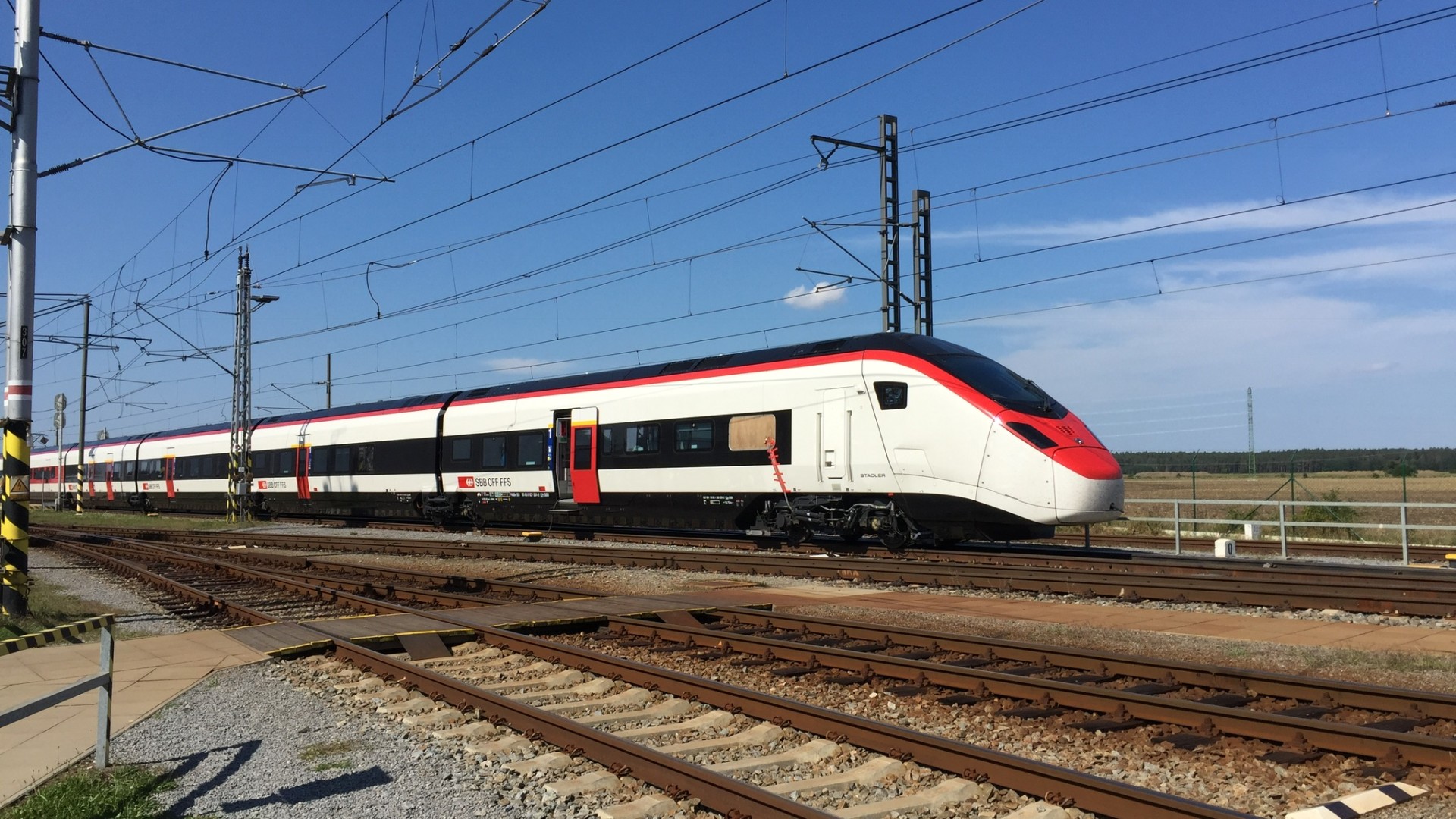 High-speed train passing on railway tracks.