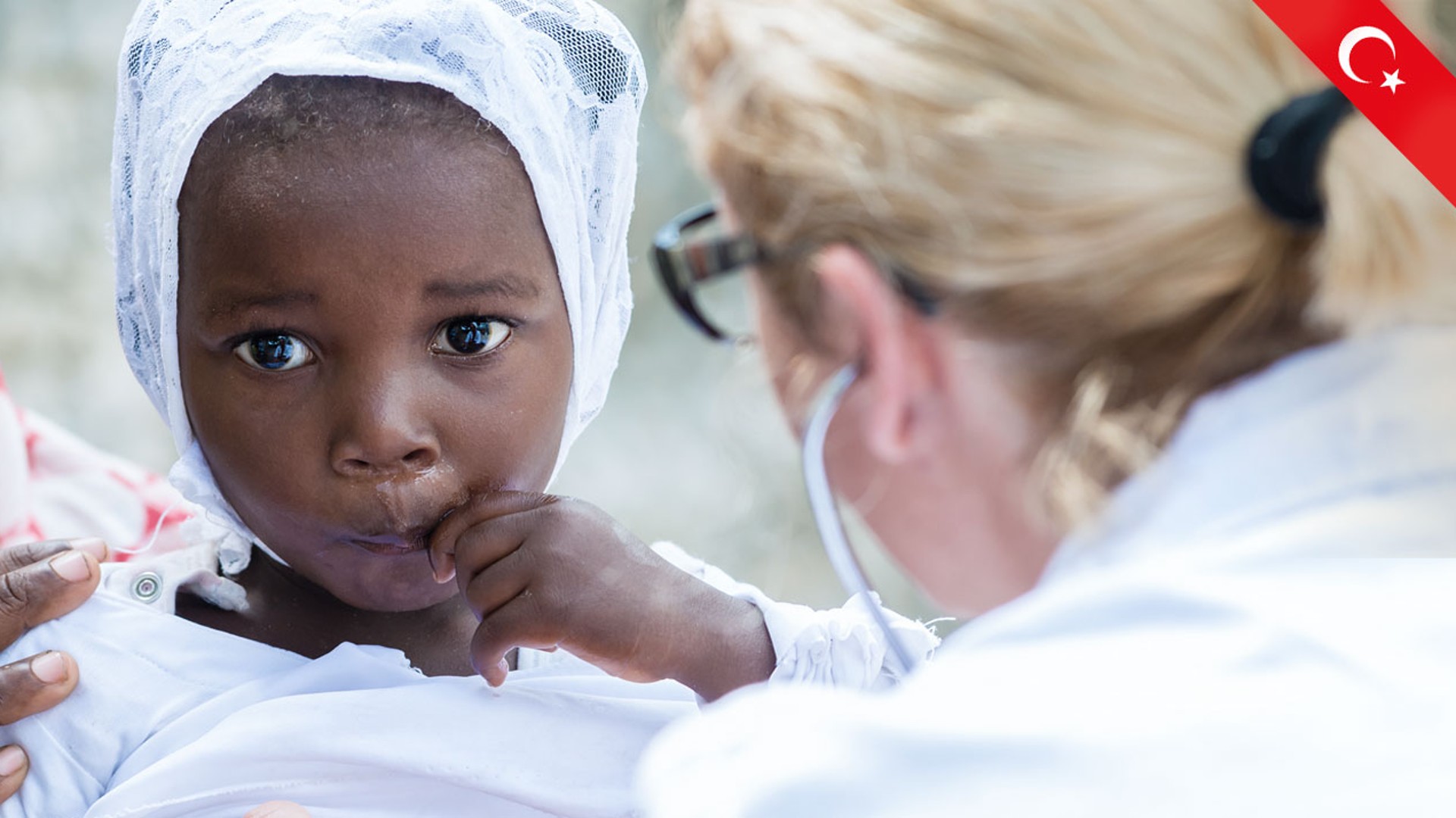 Child being examined by a healthcare professional.