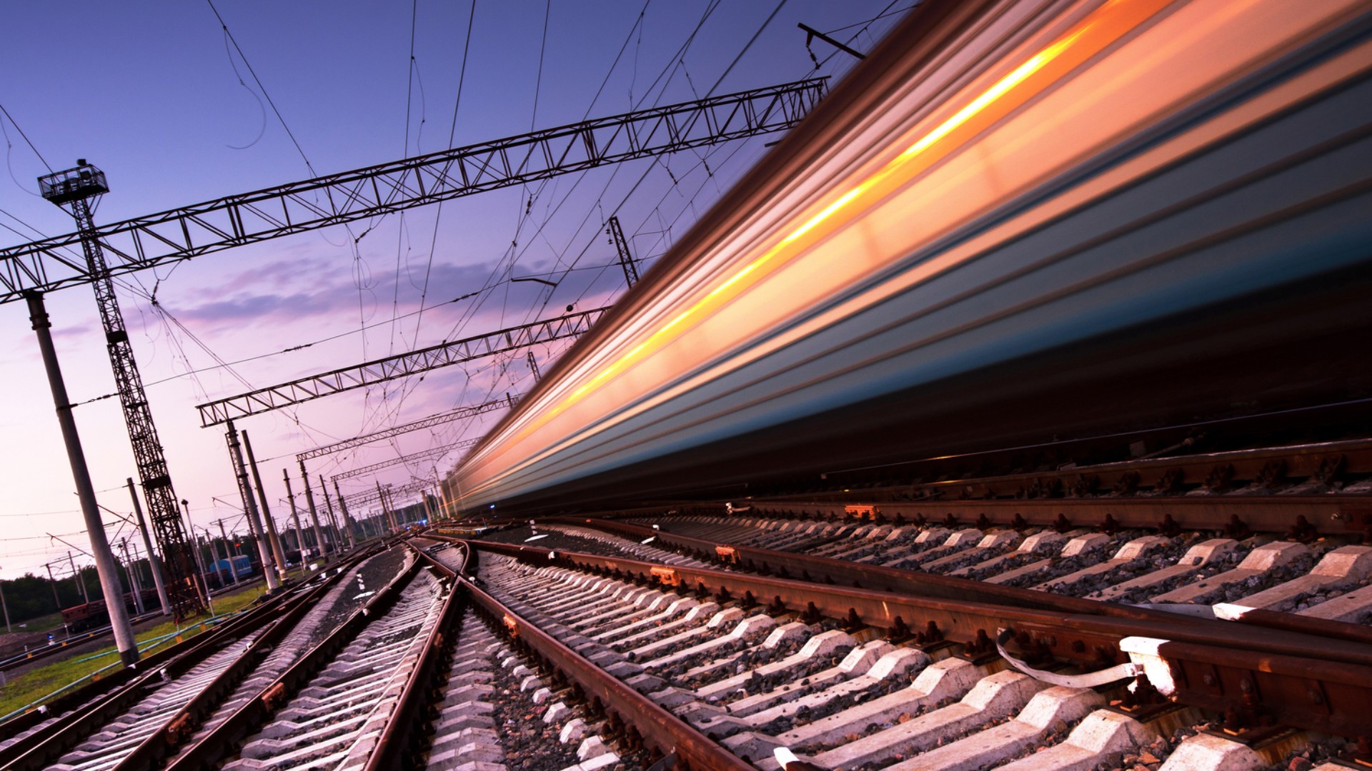 High-speed train racing along railway tracks.