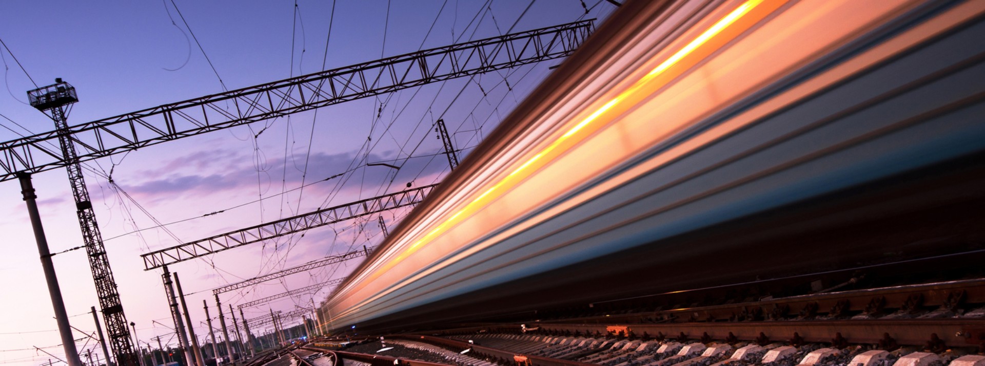 High-speed train racing along railway tracks.