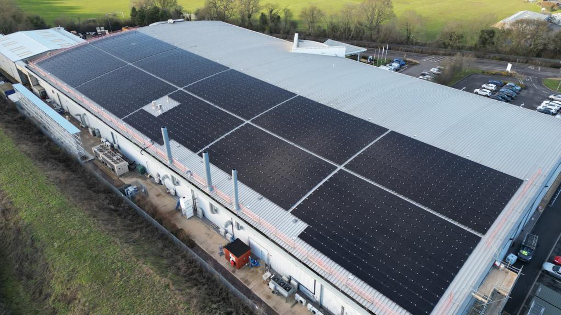 Industrial building with solar panels on roof.