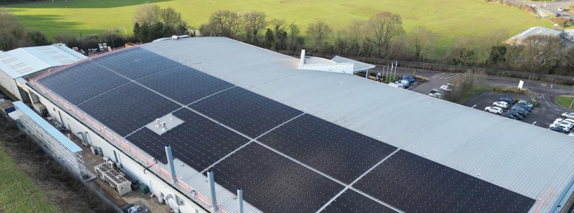 Industrial building with solar panels on roof.