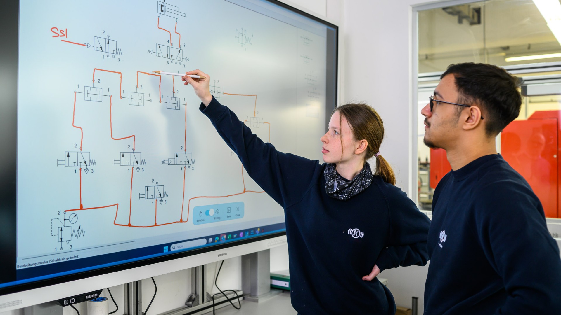 Two trainees looking at a screen.