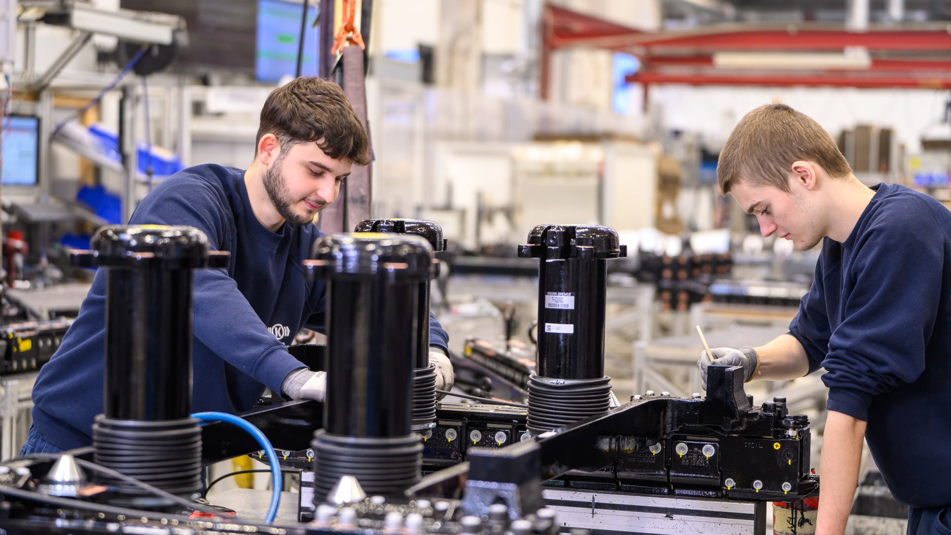 Two trainees working in a workshop.