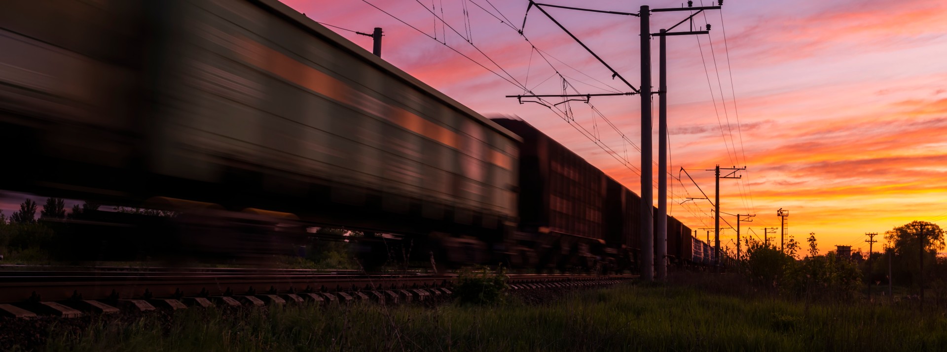 Freight train going through the sundown.
