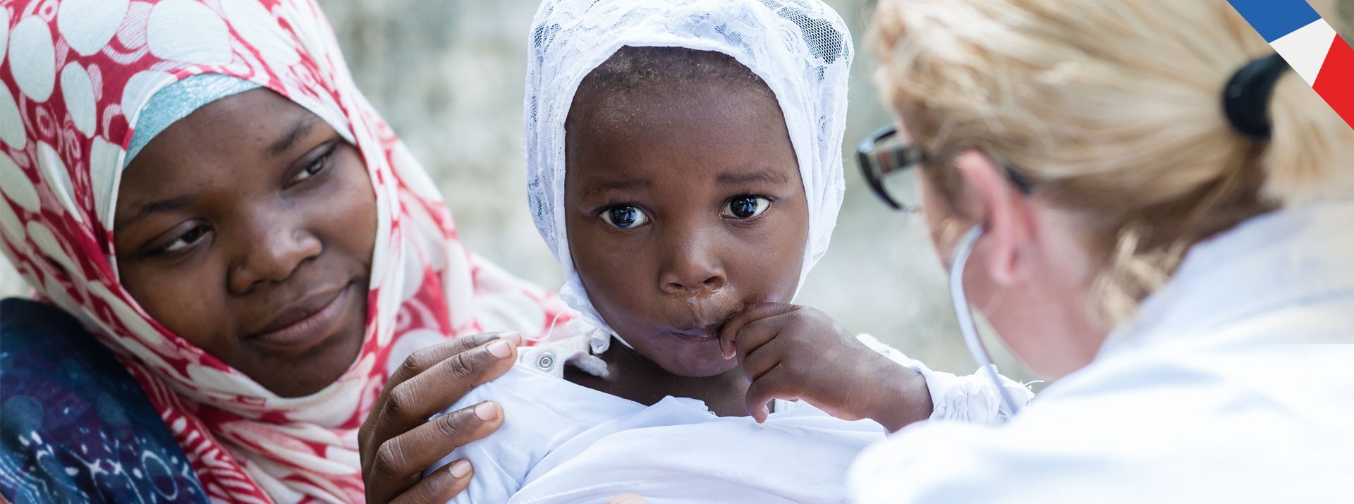 Mother caring for child during health assessment.