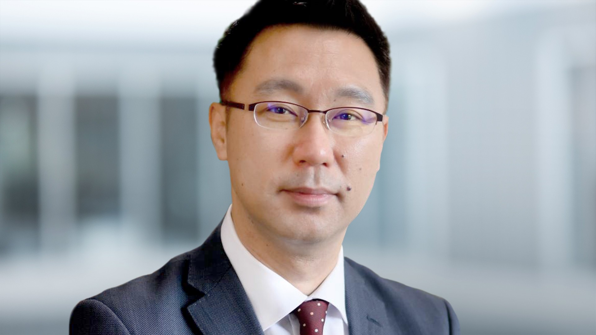 Business professional with glasses, close-up portrait.