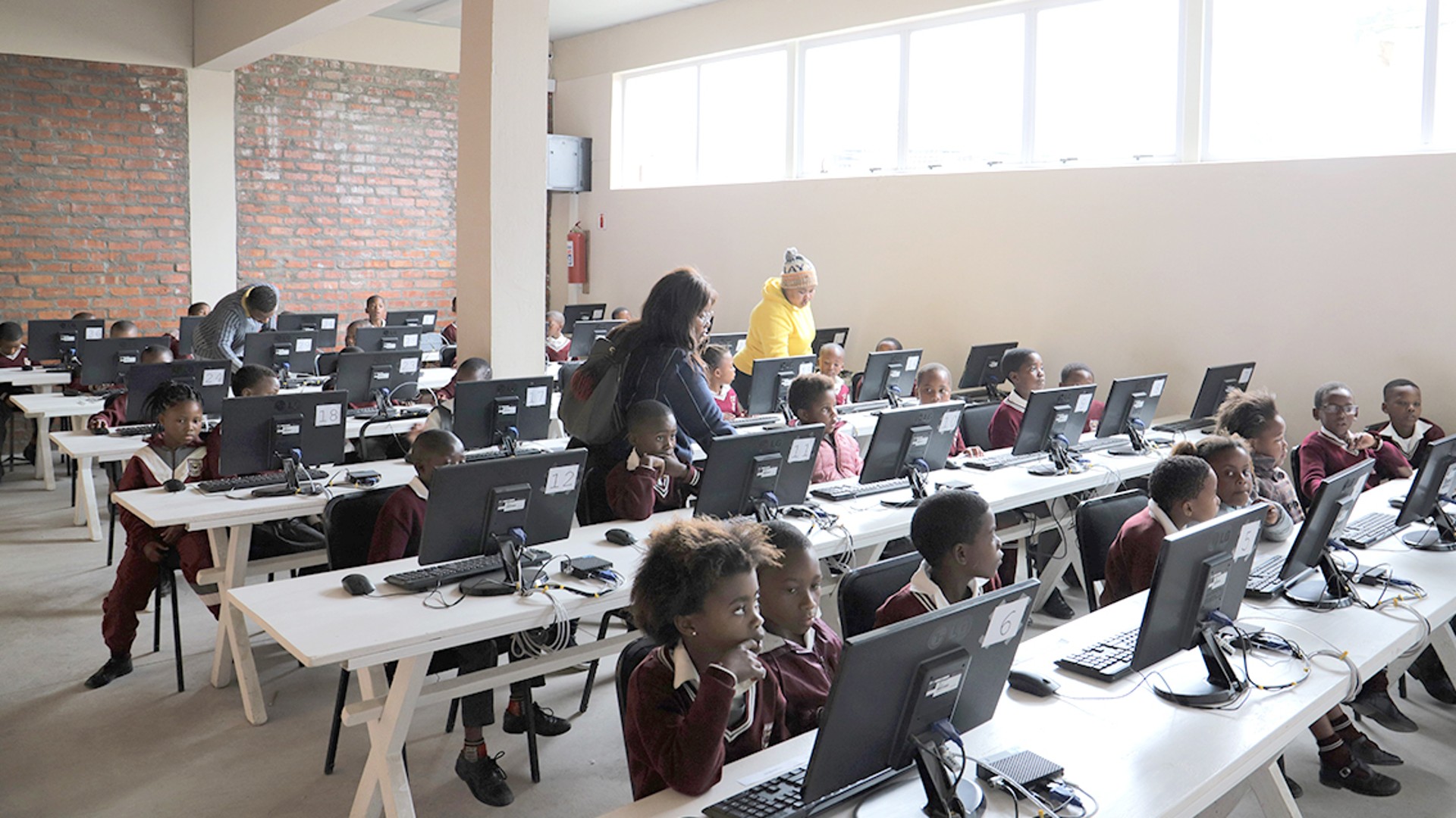 Children learning in a computer lab setting.